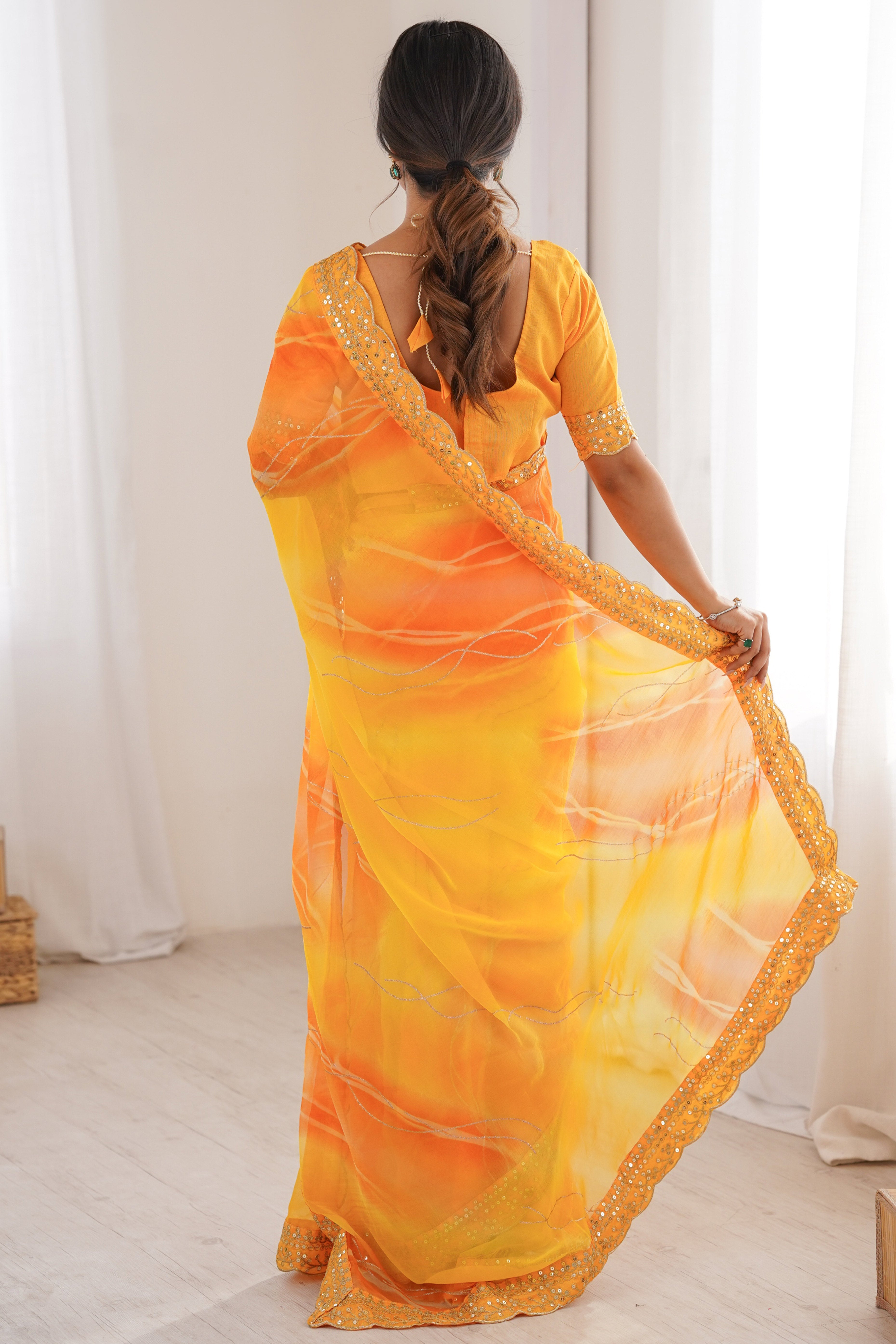Graceful Yellow Foil Print Georgette Saree Featuring A Luxurious Cording Sequins Embroidered Border