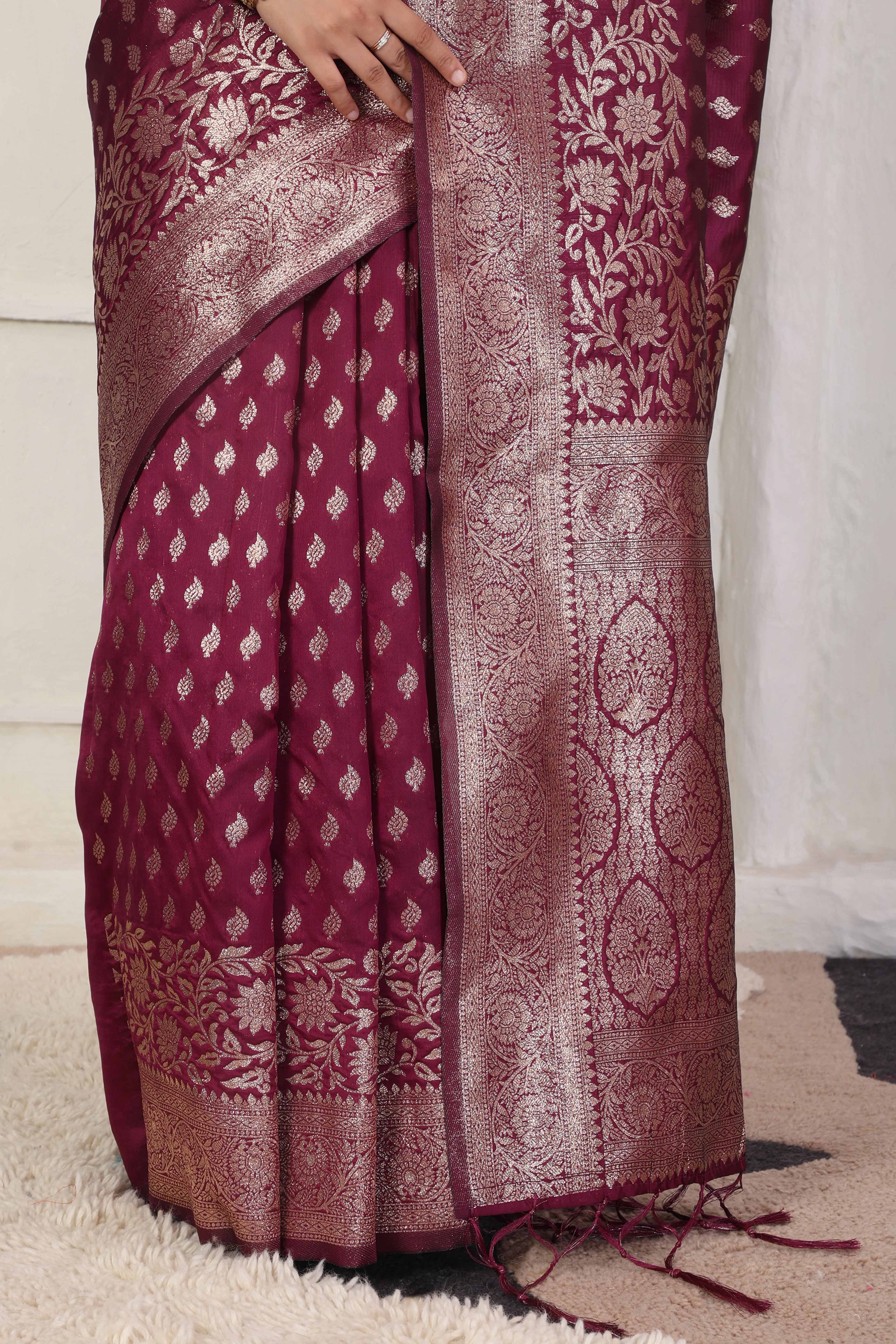 Wine Traditional Lichi Silk Blend Saree Enhanced With Floral Zari Weaving & Tassel Pallu