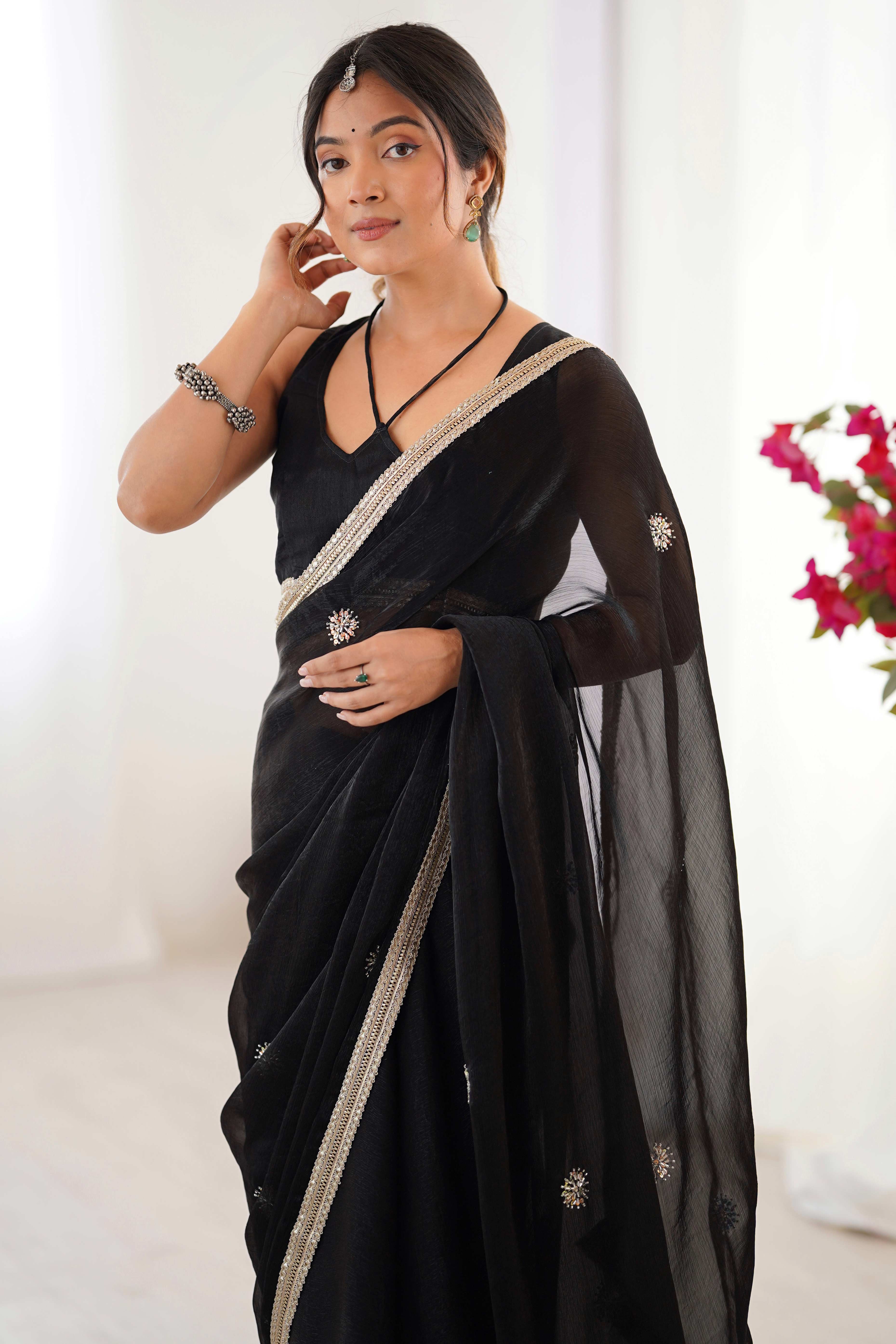 Elegant Black Organza Saree with Delicate Floral Embellishments and Lace Border