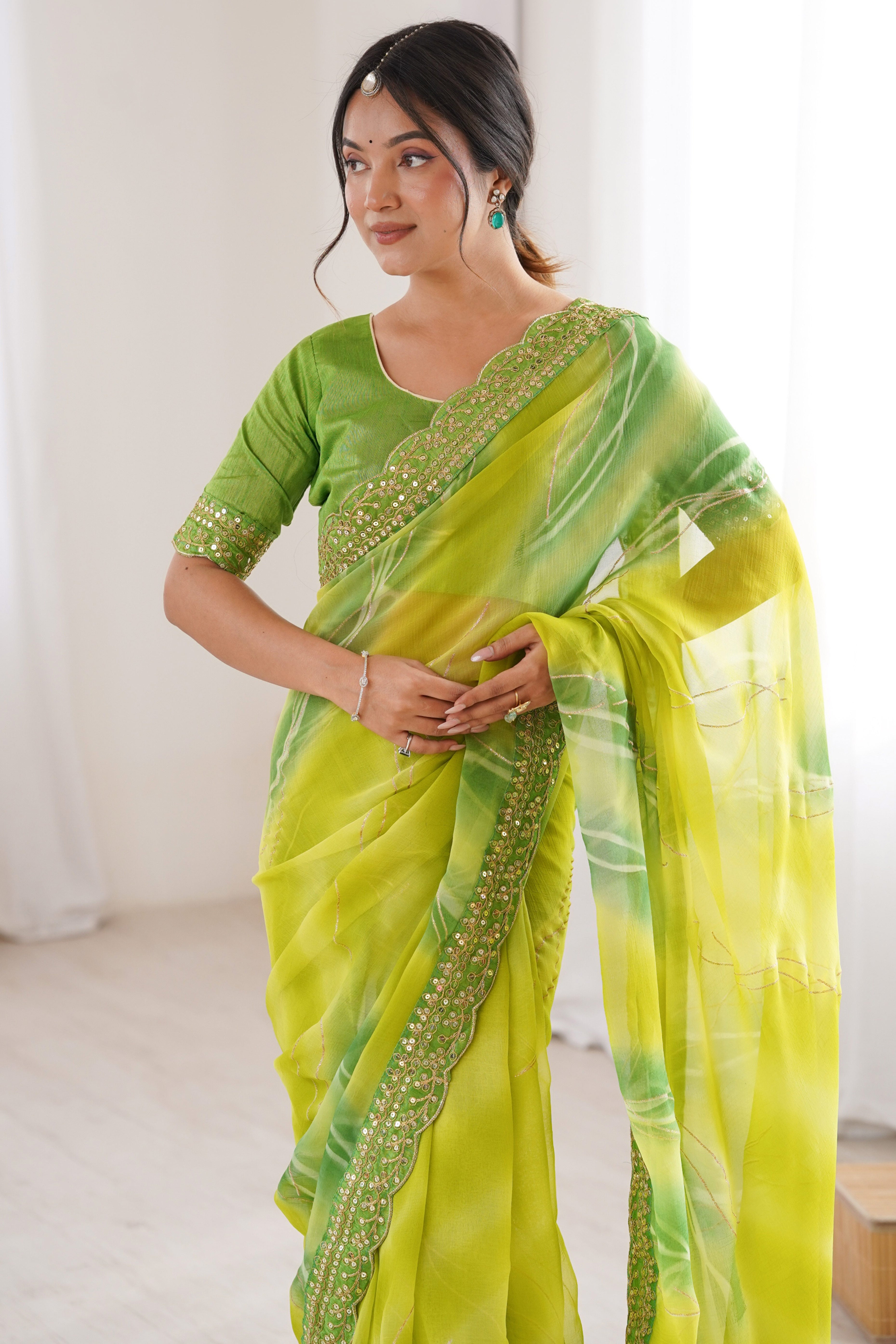 Graceful Green Foil Print Georgette Saree Featuring A Luxurious Cording Sequins Embroidered Border