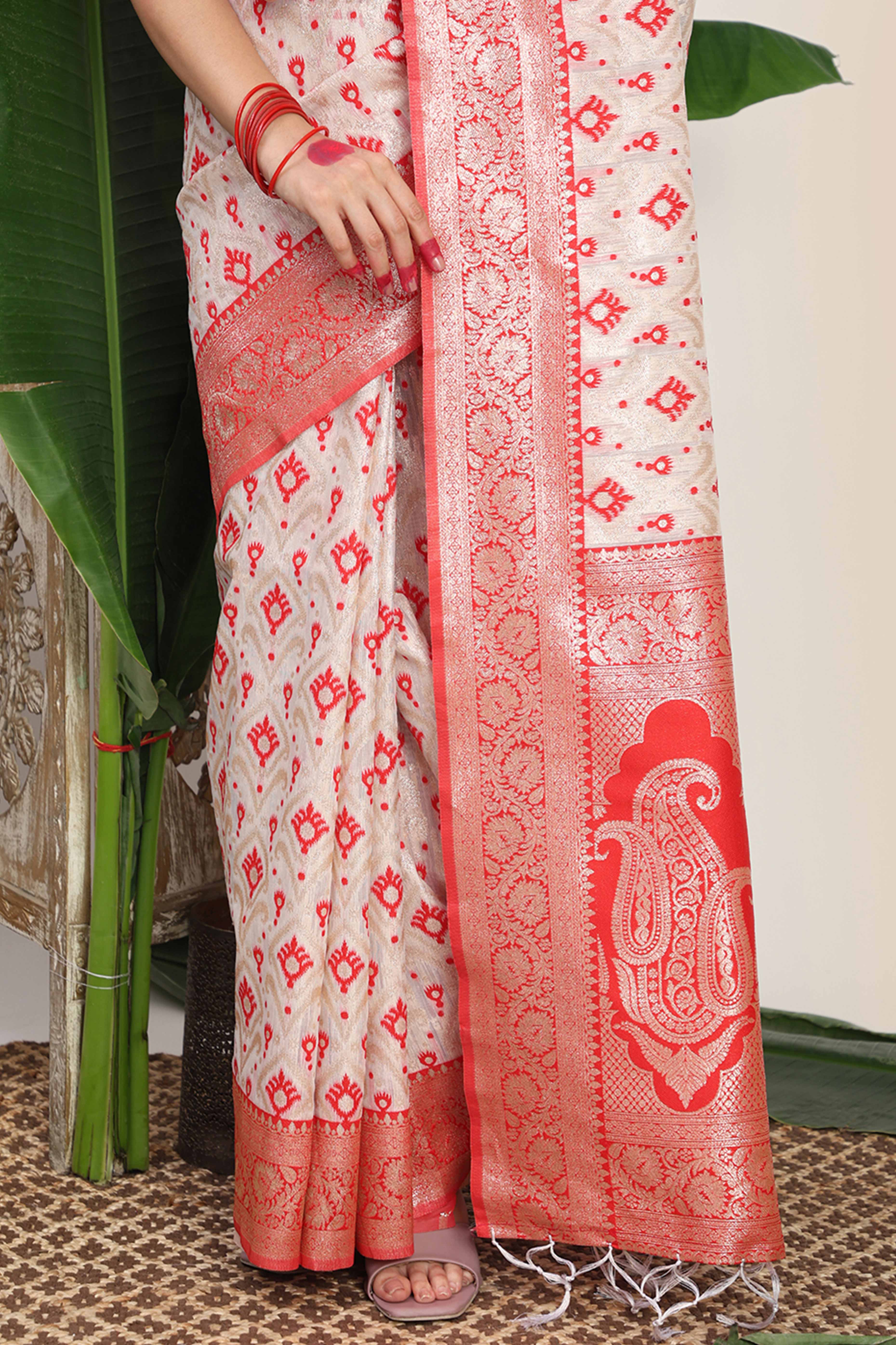 White & Red Linen Cotton Saree Accented With Rich Zari Weaving And A Decorative Tassel Pallu