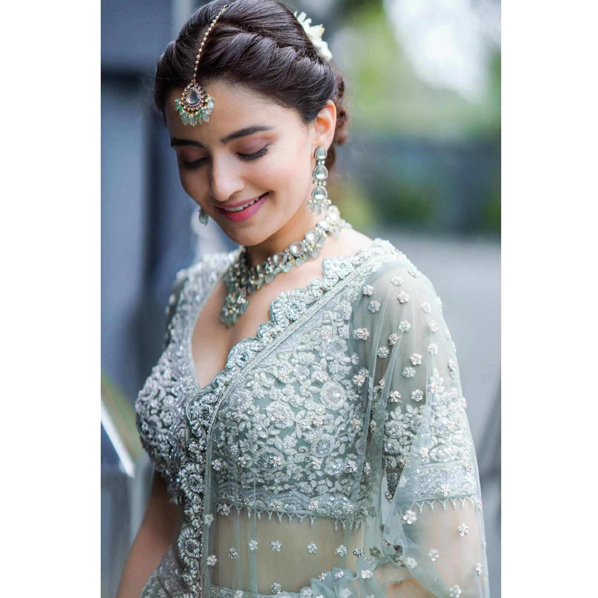 Aqua Green Party Wear Heavy Embroidered Netted Lehenga Choli - Peachmode