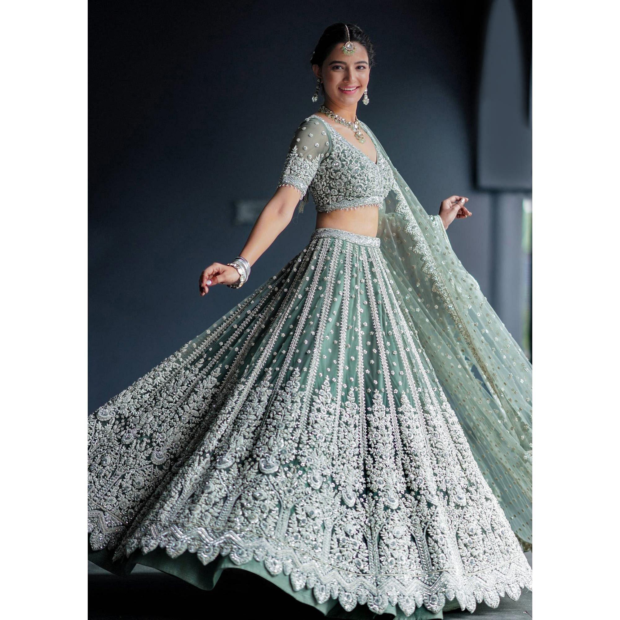 Aqua Green Party Wear Heavy Embroidered Netted Lehenga Choli - Peachmode