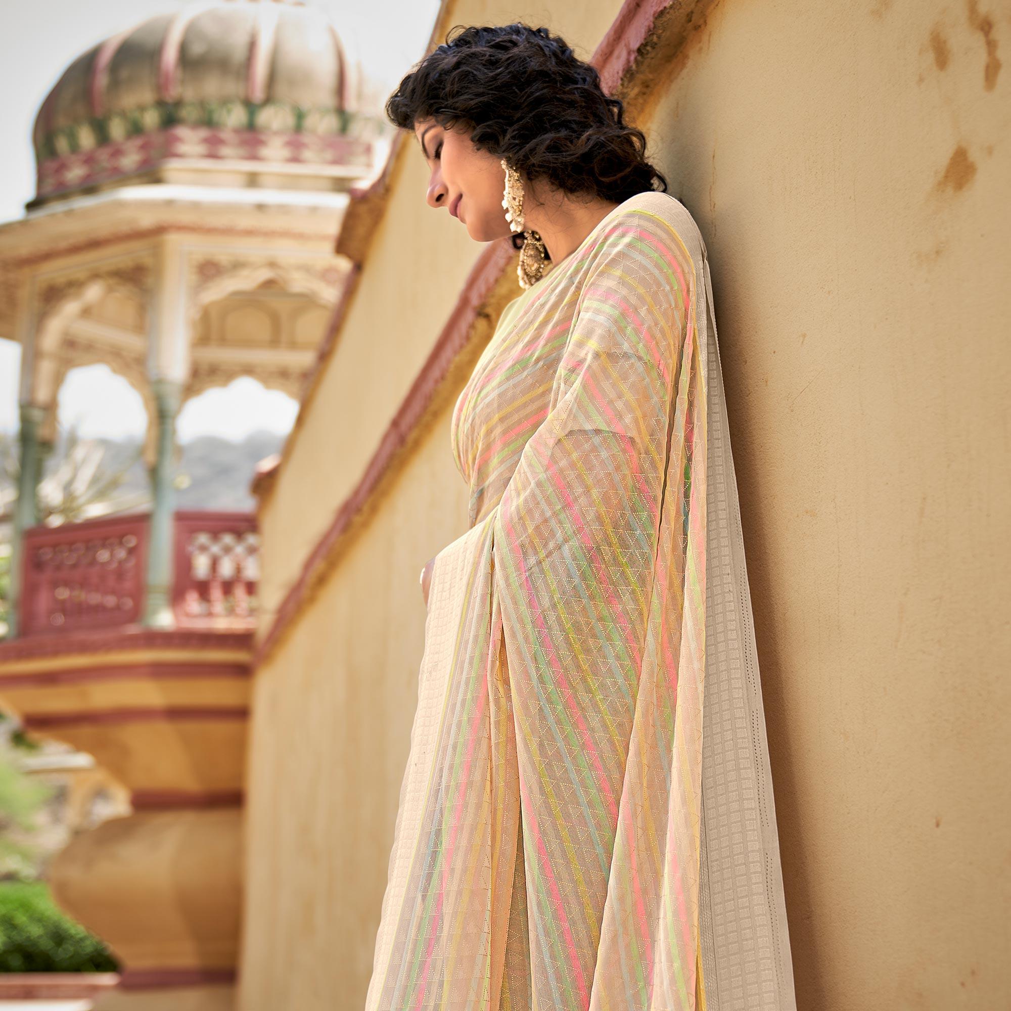 Beige Printed Georgette Saree With Tassels - Peachmode