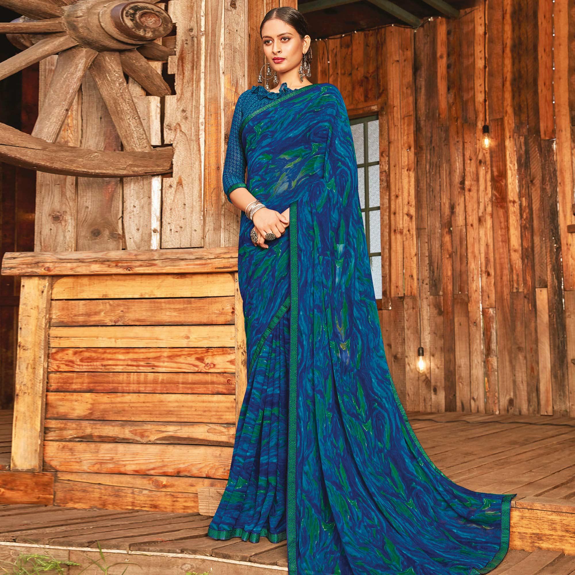 Captivating Rama & Blue Coloured Partywear Pure Georgette Floral Printed Saree With Fancy Lace Border - Peachmode
