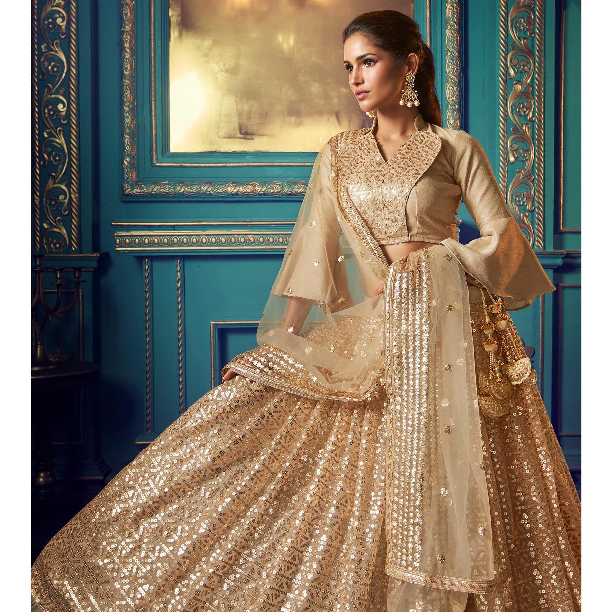 Dazzling Beige Colored Partywear Embroidered Soft Net Lehenga Choli - Peachmode