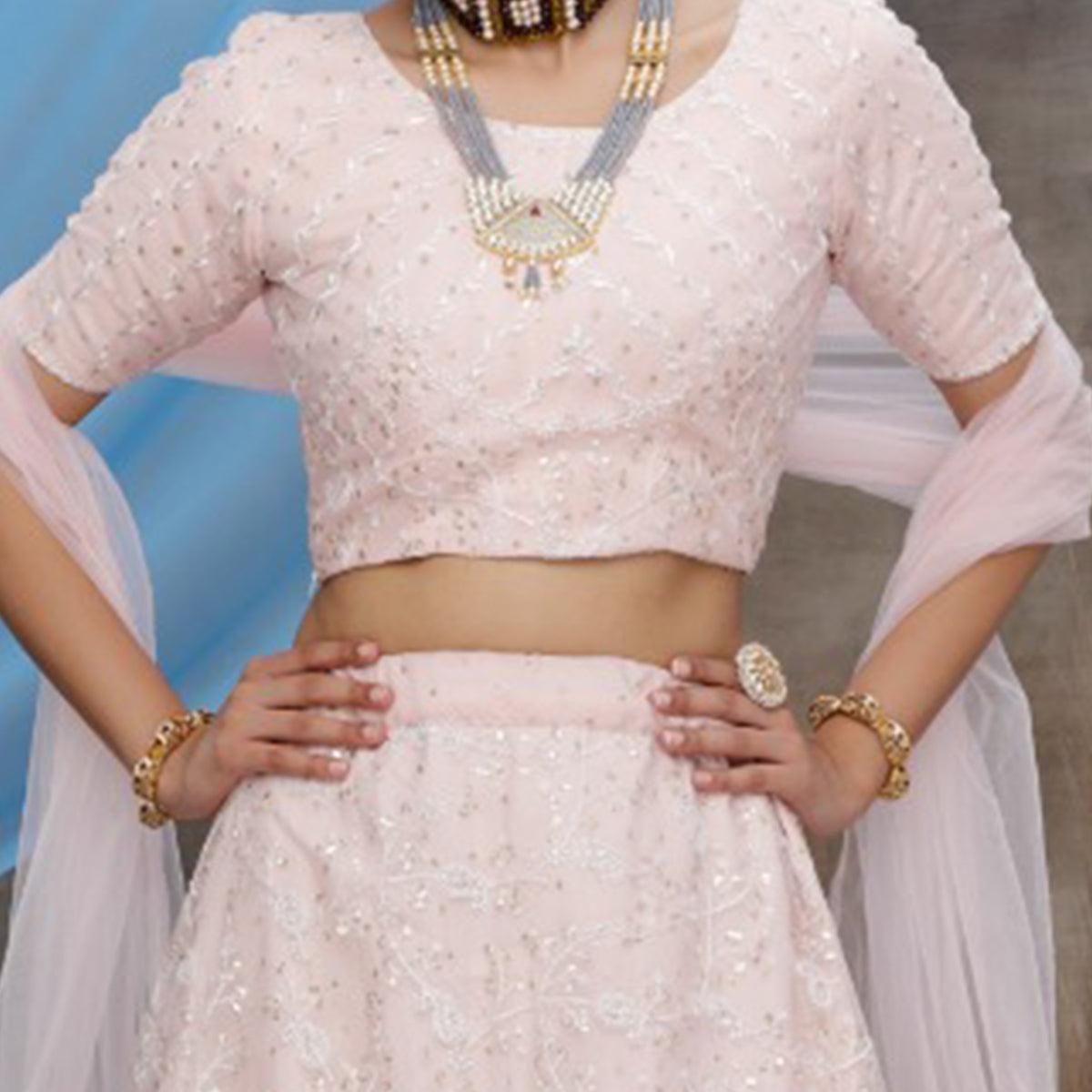 Desirable Pastel Peach Colored Party Wear Embroidered Net Lehenga Choli - Peachmode