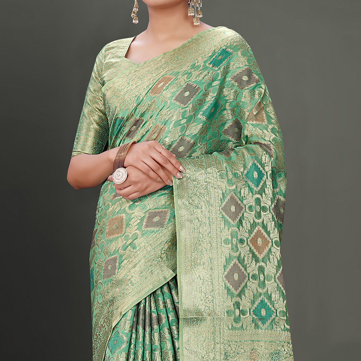 Rama Green Woven Organza Saree With Tassels