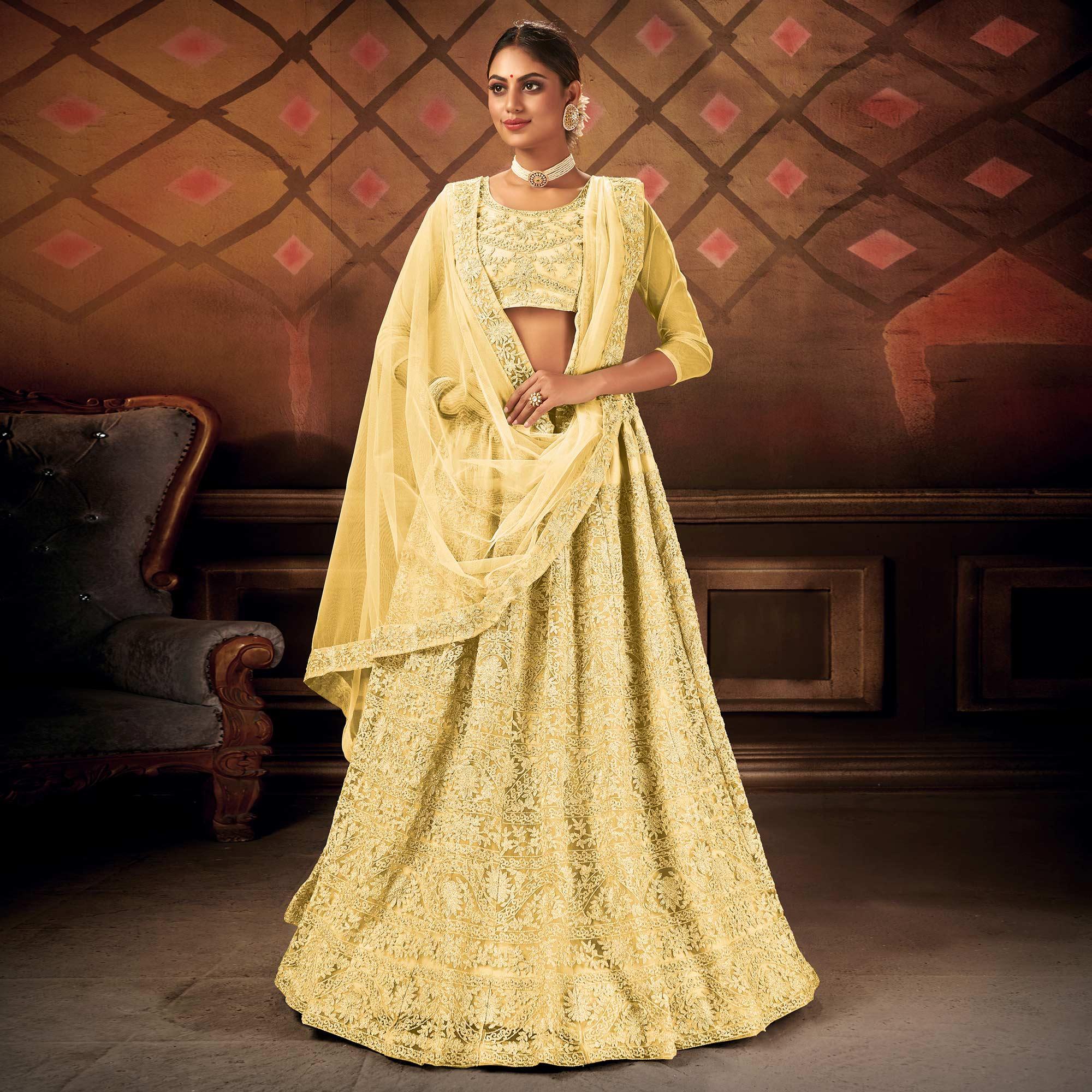 Glowing Yellow Colored Partywear Embroidered Net Lehenga Choli - Peachmode