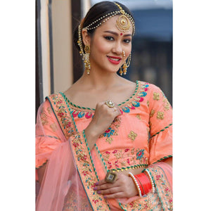 Hypnotic Peach Colored Party Wear Embroidered Silk Lehenga Choli - Peachmode