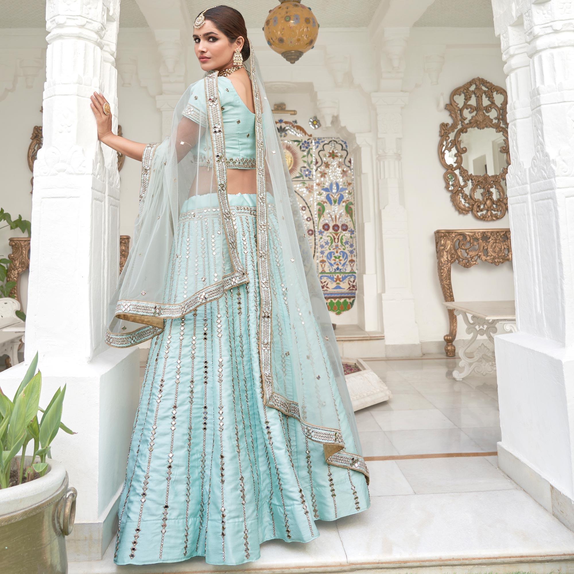 Intricate Ice Blue Coloured Wedding Wear Mirror Work Heavy Silk Lehenga Choli - Peachmode