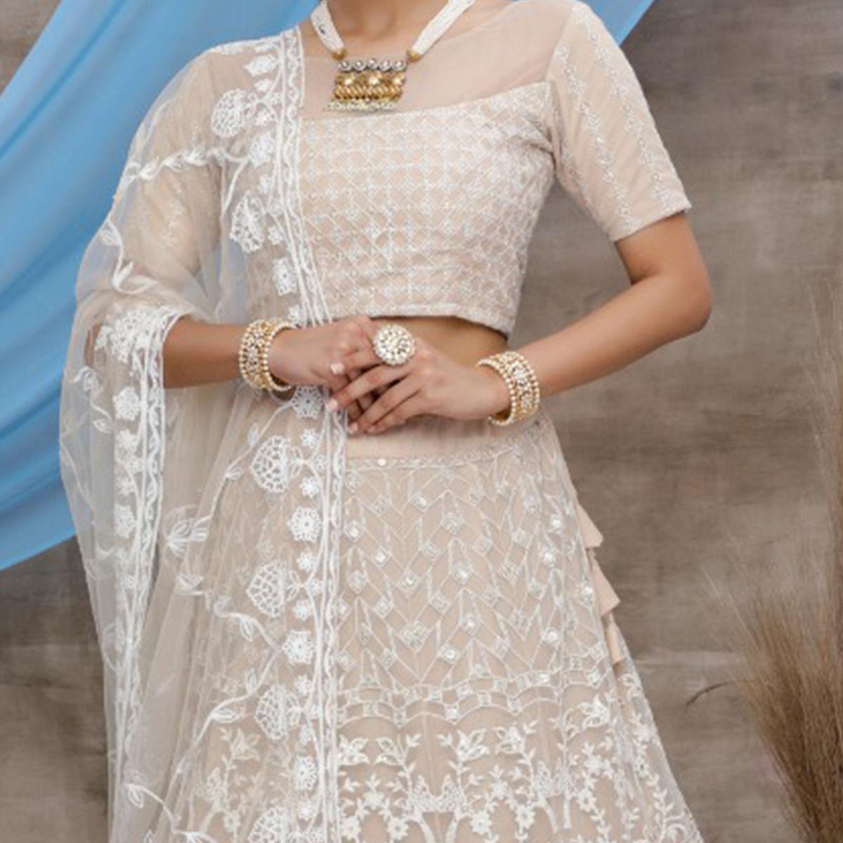 Opulent Beige Colored Party Wear Embroidered Net Lehenga Choli - Peachmode