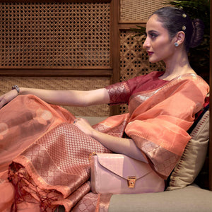 Orange Woven Organza Saree With Tassels - Peachmode