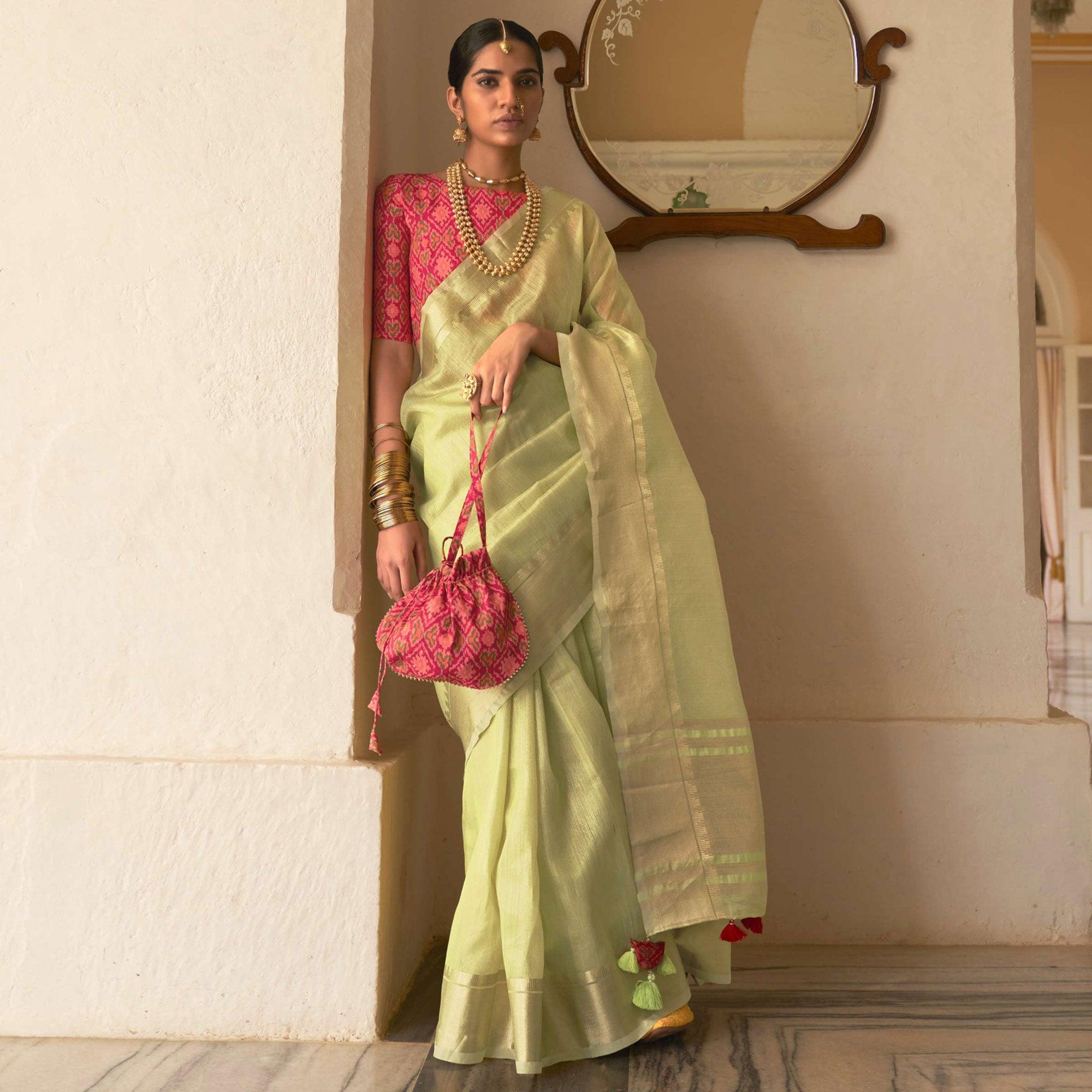 Pista Green Woven Organza Saree With Tassels - Peachmode