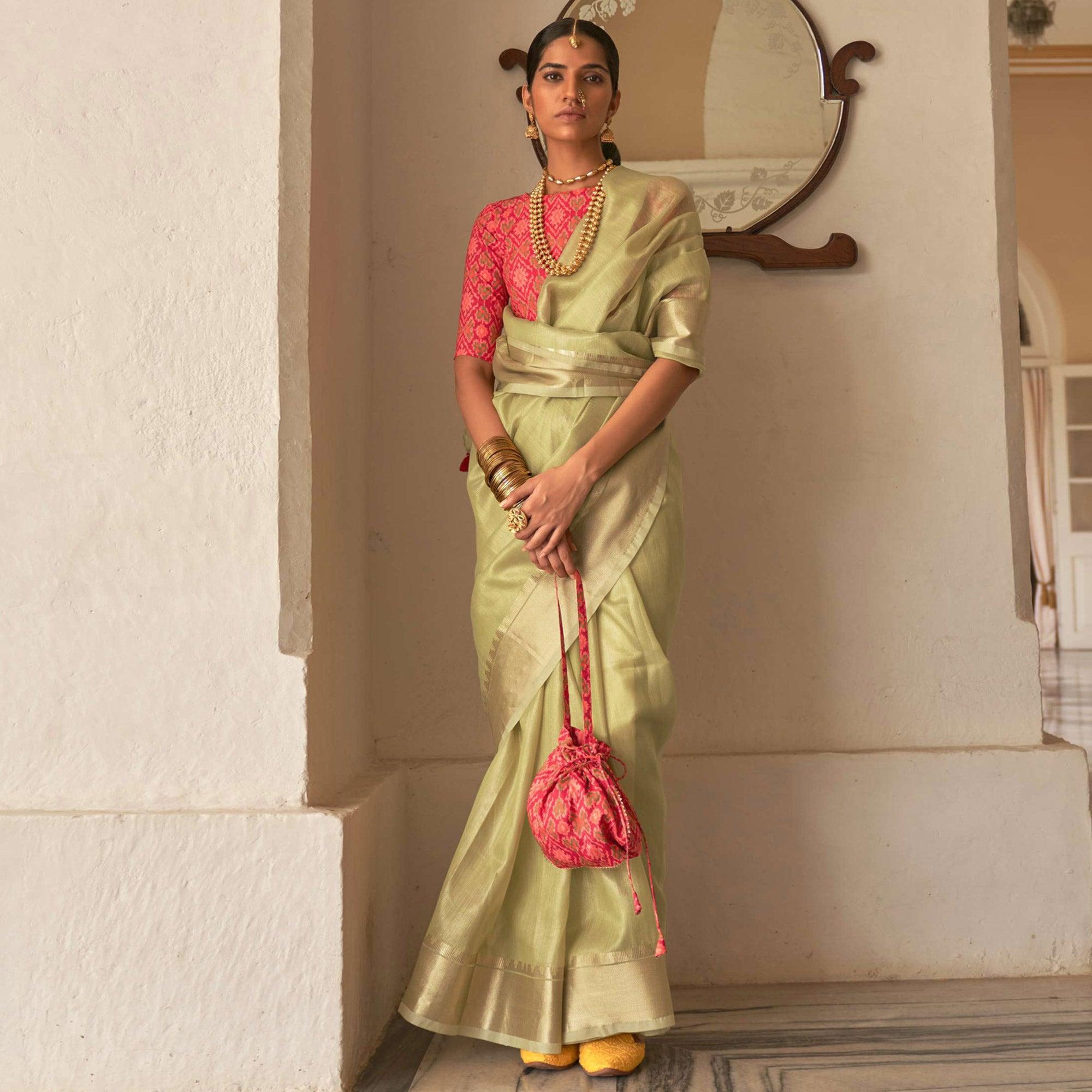 Pista Green Woven Organza Saree With Tassels - Peachmode