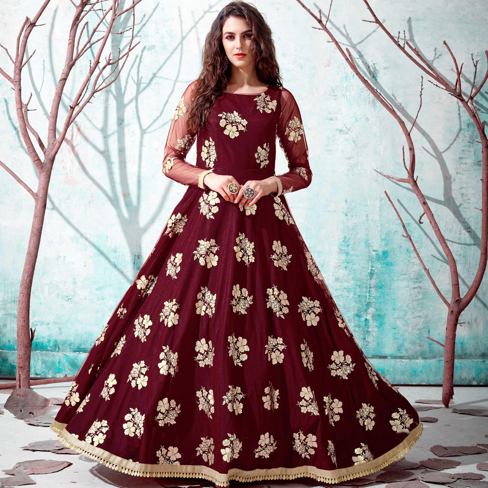 Ravishing Maroon Coloured Partywear Metallic Foil Work Net Gown - Peachmode