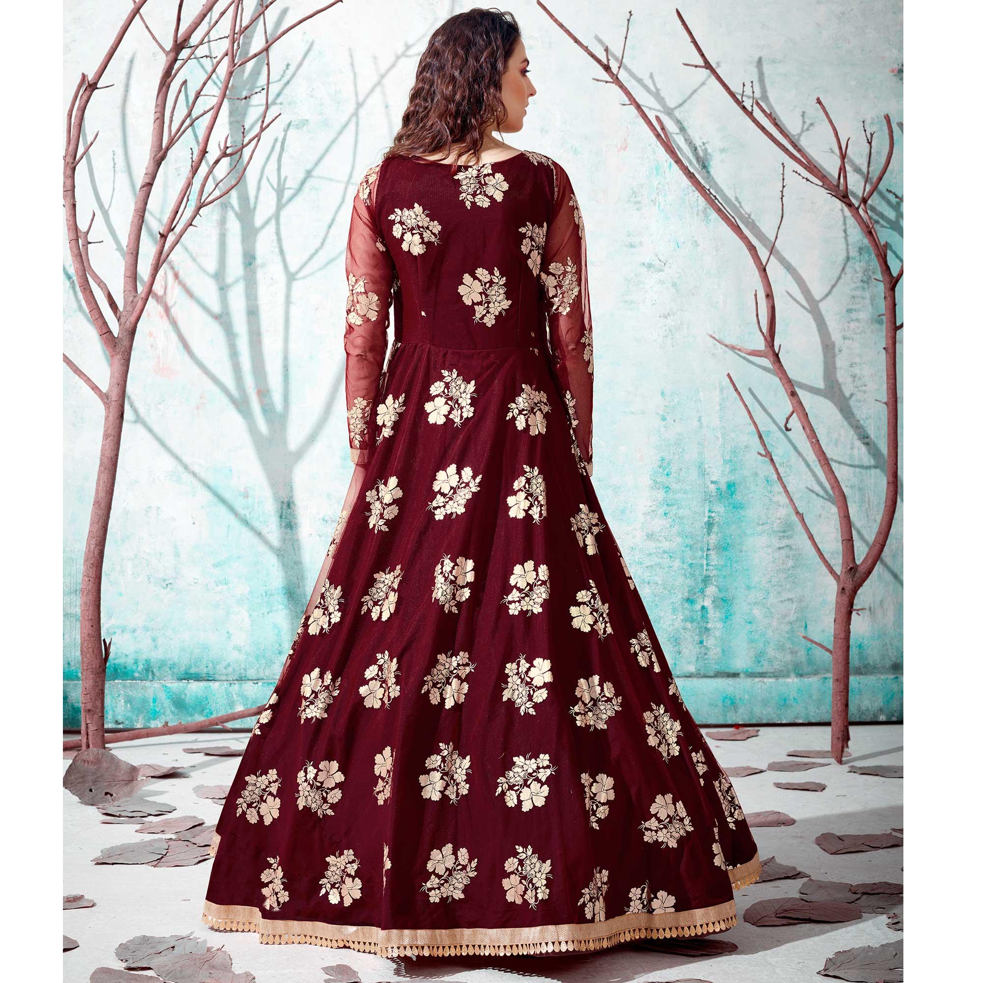 Ravishing Maroon Coloured Partywear Metallic Foil Work Net Gown - Peachmode