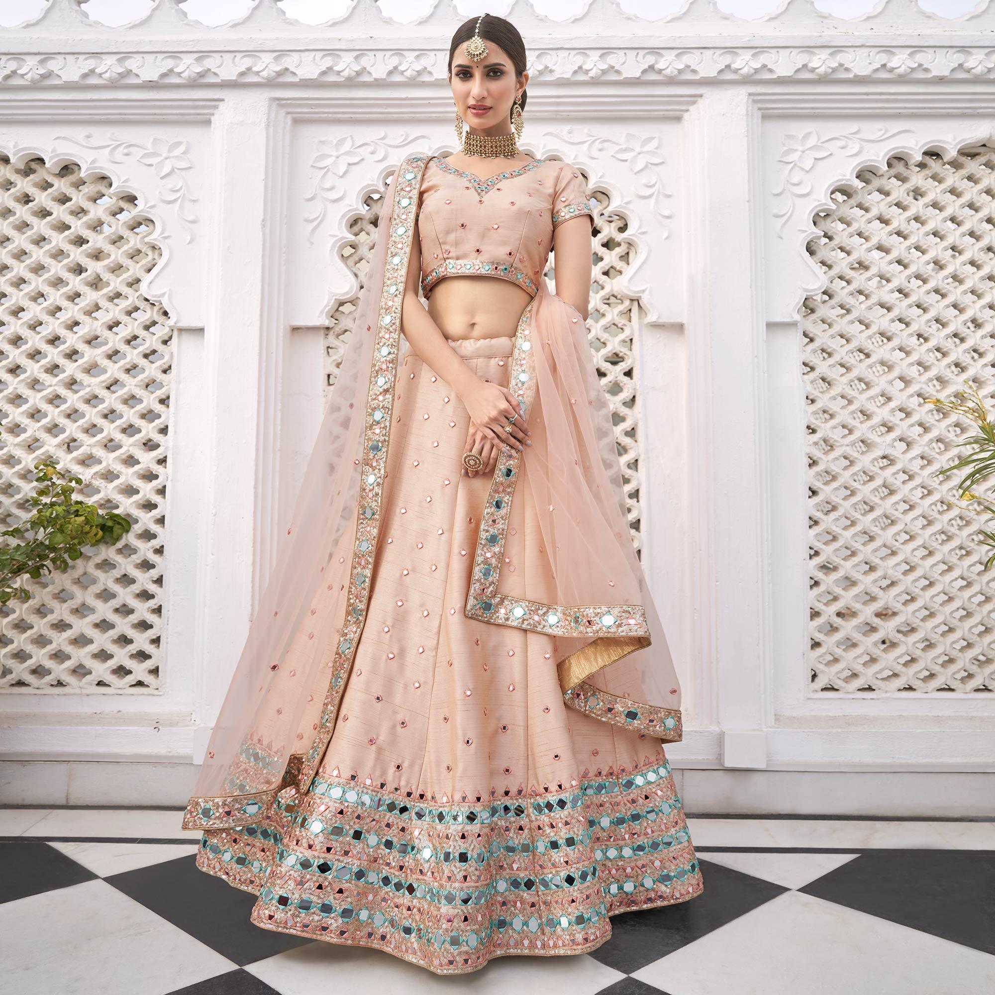 Sophisticated Peach Coloured Wedding Wear Mirror Work Heavy Silk Lehenga Choli - Peachmode