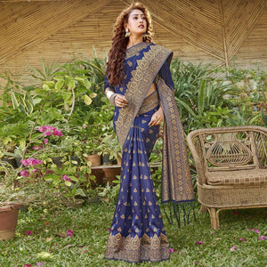 Staring Navy Blue Colored Festive Wear Geomatric Woven Silk Blend Saree With Tassels - Peachmode