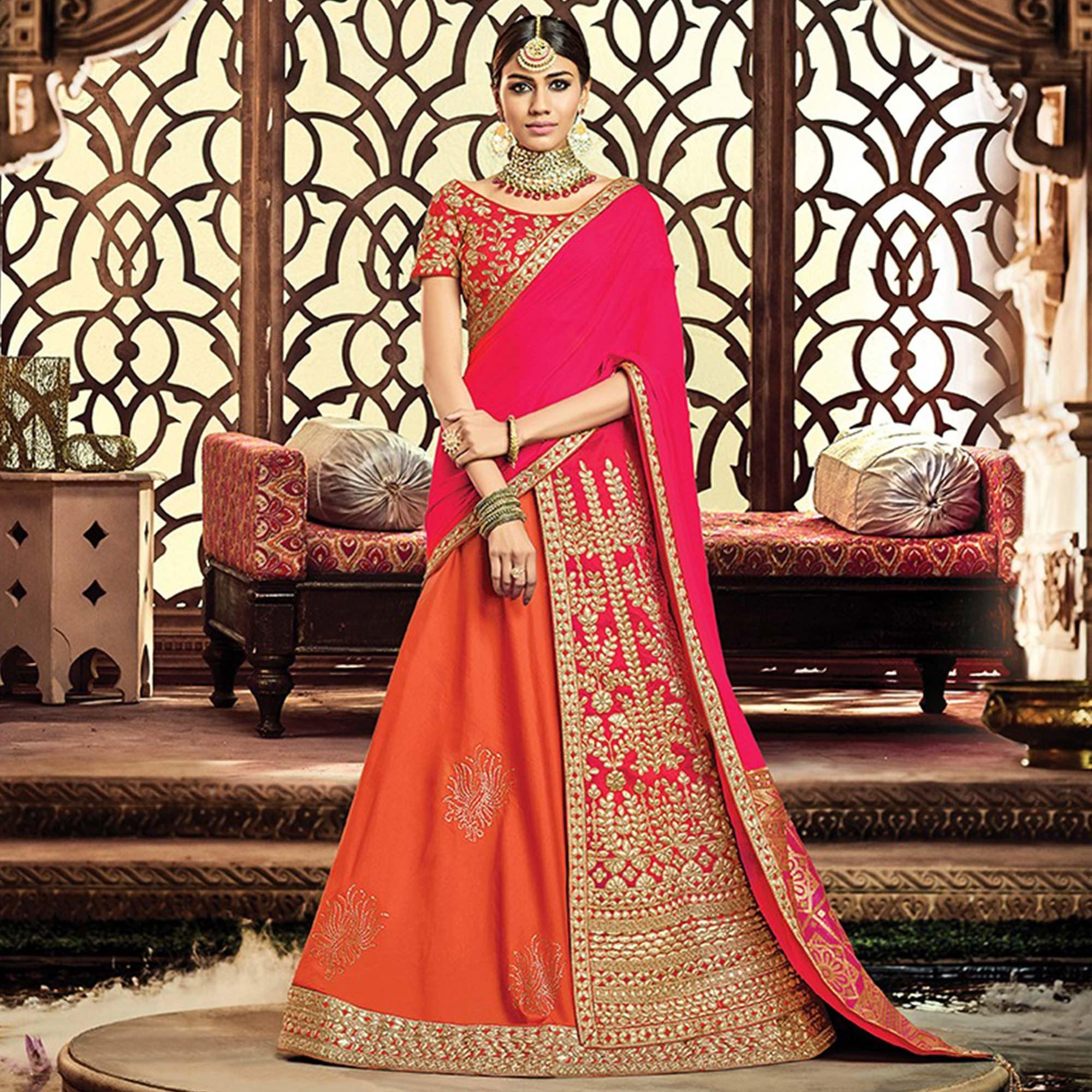 Unique Orange-Pink Colored Designer Embroidered Wedding Wear Tapeta-Raw Silk Lehenga Saree - Peachmode