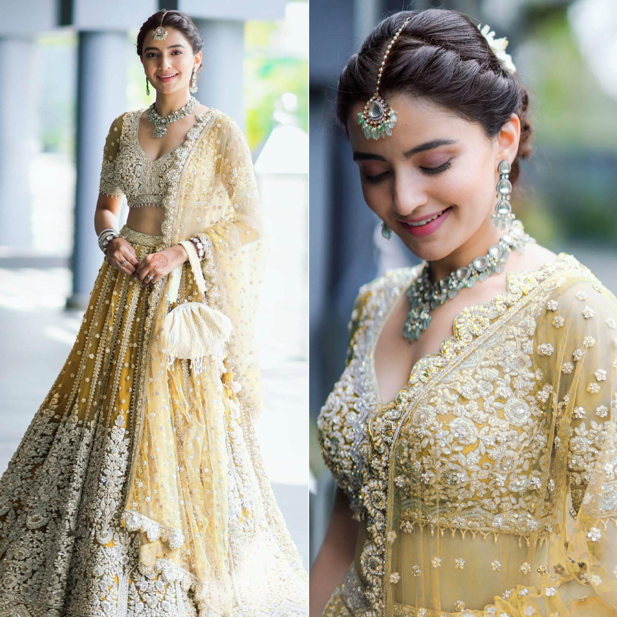 Yellow Heavy Embroidered Netted Lehenga Choli - Peachmode