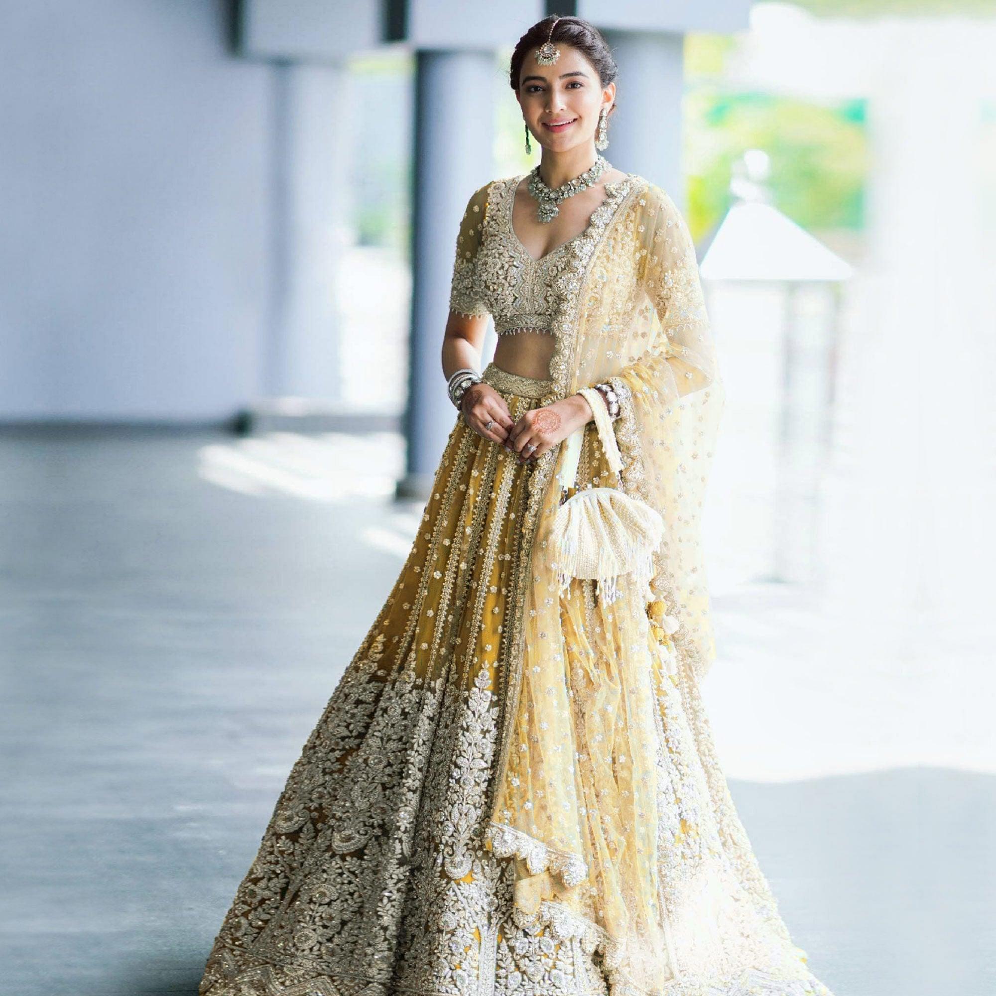 Yellow Heavy Embroidered Netted Lehenga Choli - Peachmode