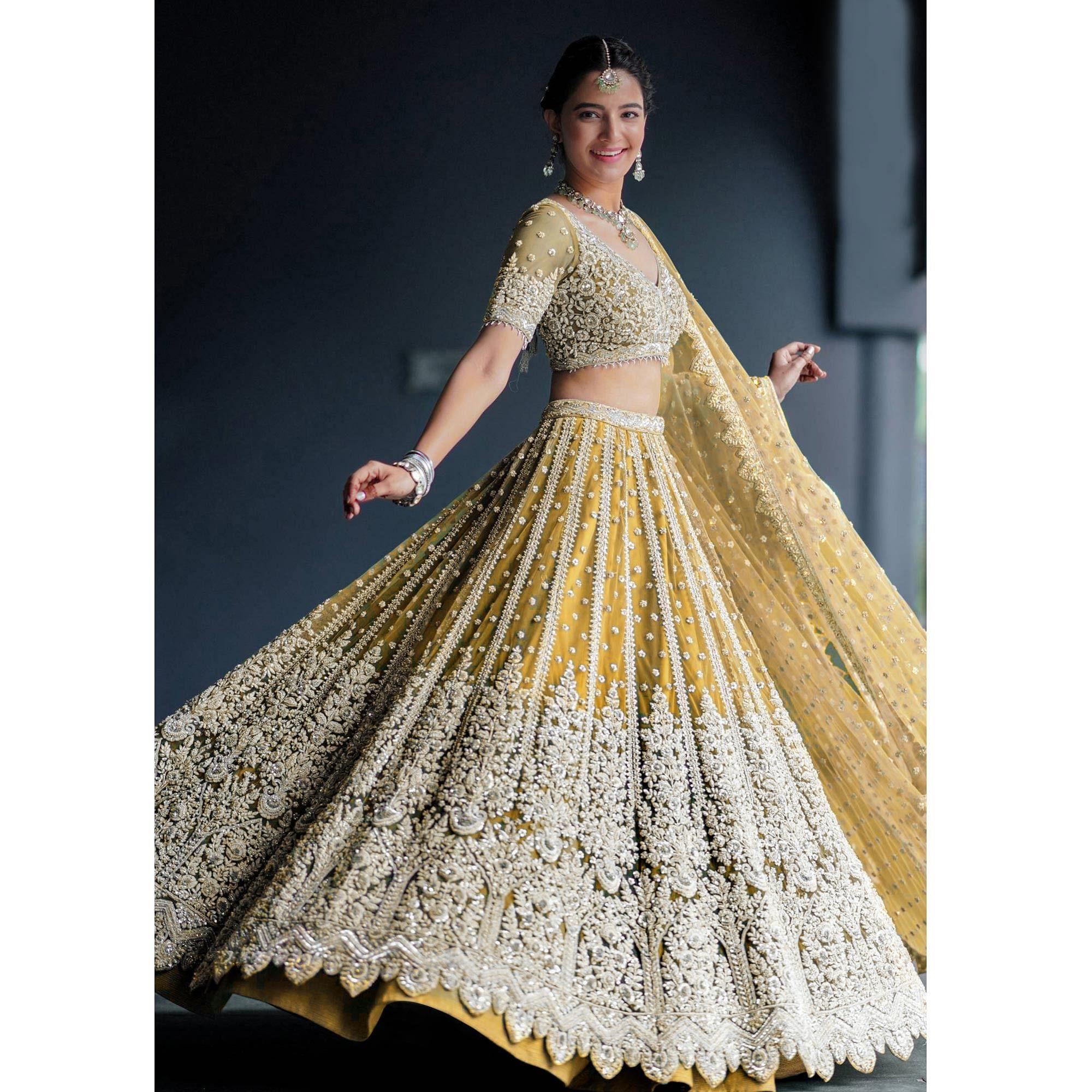 Yellow Heavy Embroidered Netted Lehenga Choli - Peachmode