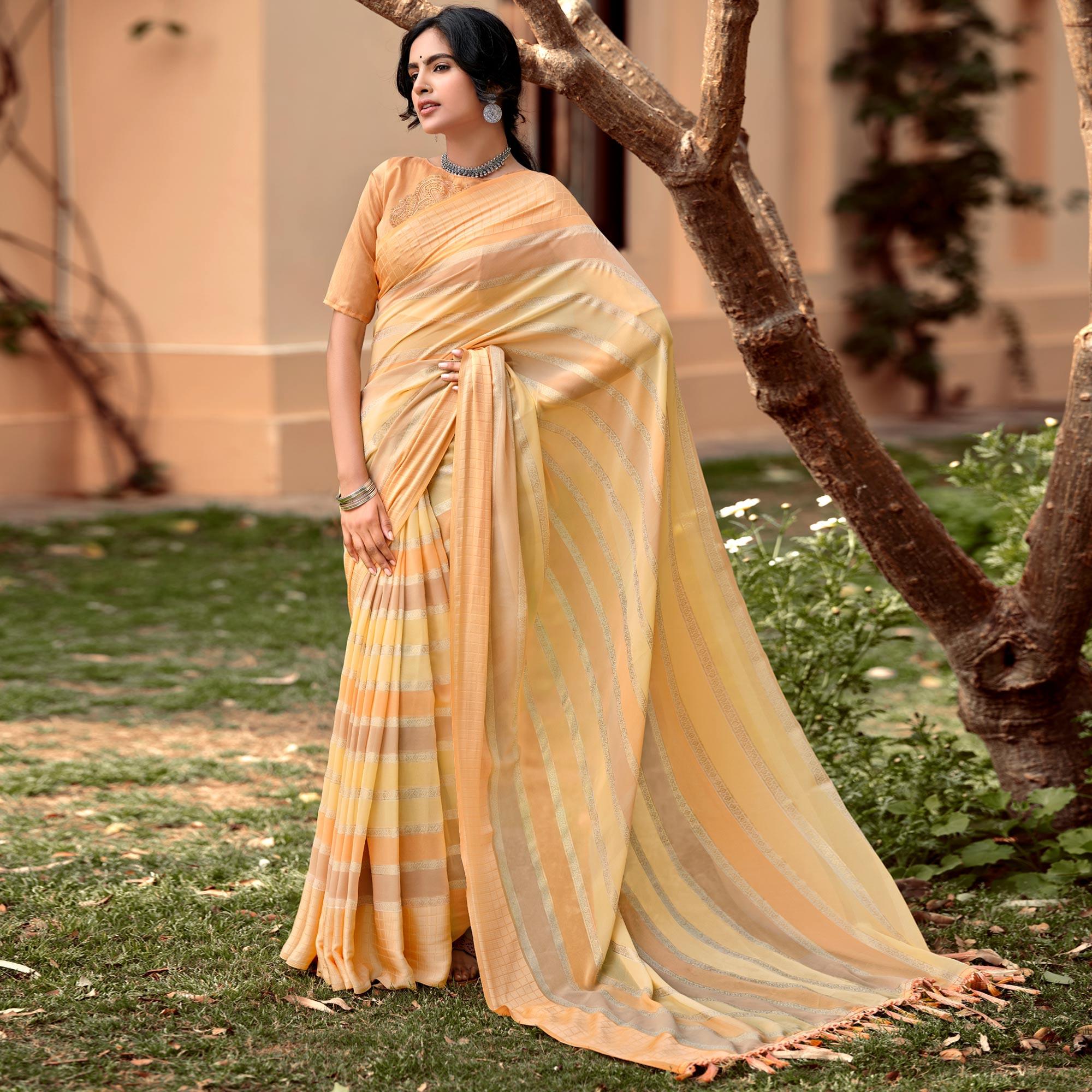 Yellow-Orange Party Wear Foil Printed Georgette Saree With Tassels - Peachmode