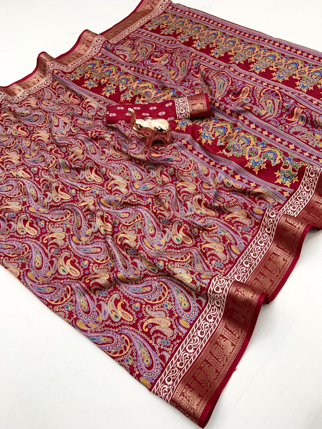 Maroon Paisley Printed Dola Silk Saree with Detailed Zari Border and Graceful Fluid Drape - Image 1