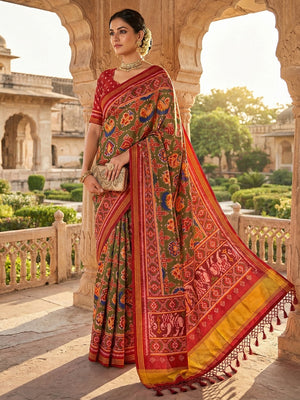 Exquisite Mehendi Green Patola Print Handloom Silk Saree with Handcrafted Tassel Detailing - Image 1