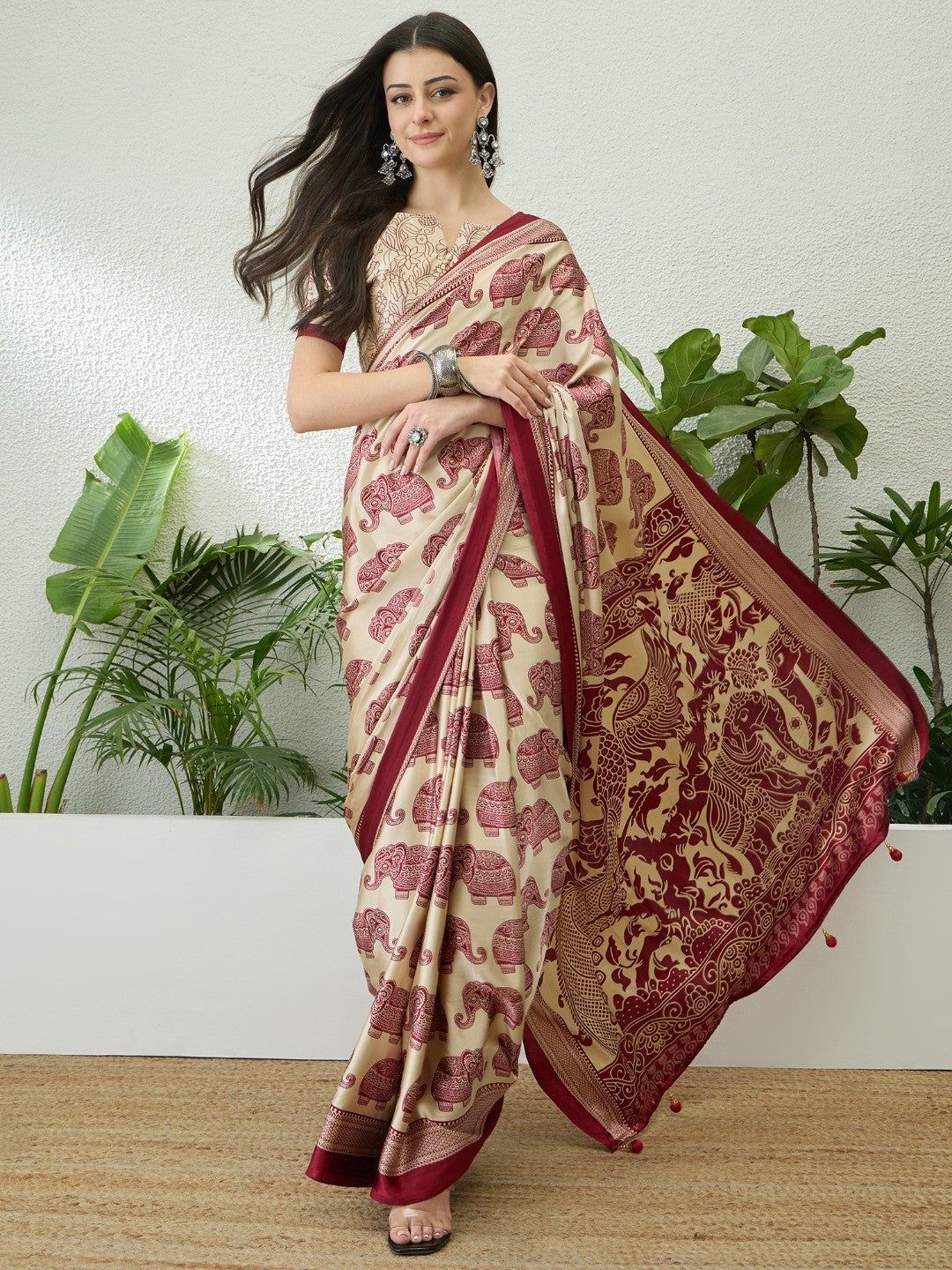 Premium Cream Satin Saree With Artistic Elephant Print And Tassel Pallu Accent - Image 1