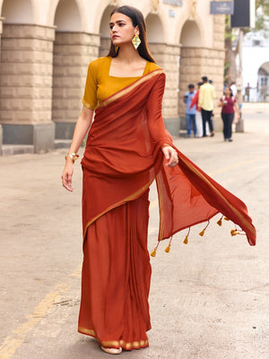 Charming Rust Solid Mulmul Cotton Saree Highlighted By Zari Weaving Border & Tassel Pallu - Image 1