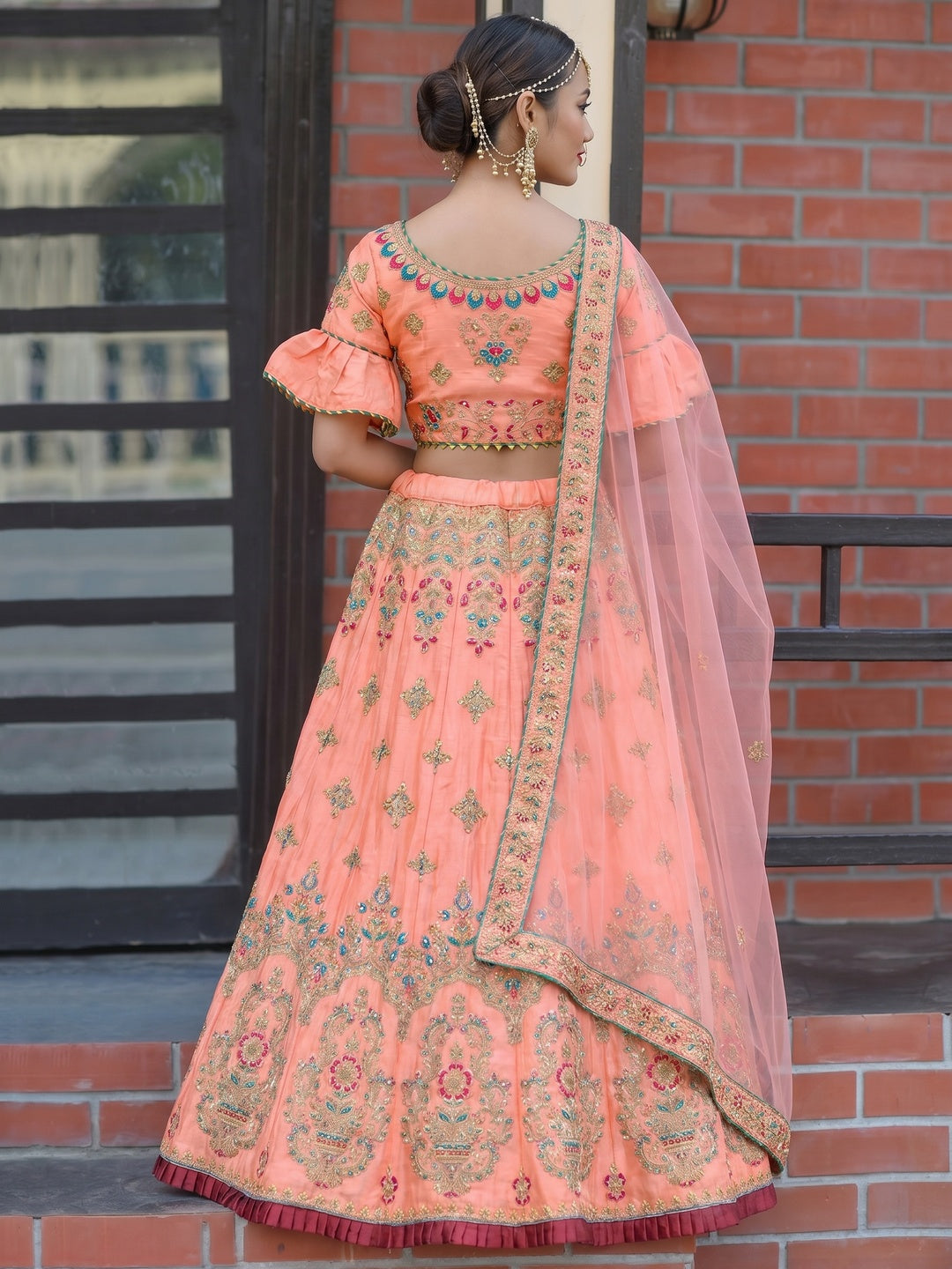Hypnotic Peach Colored Party Wear Embroidered Silk Lehenga Choli - Image 1