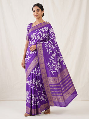 Luxurious Royal Purple Floral Print Dola Silk Saree With Intricate Peacock Motif Zari Woven Border - Image 1