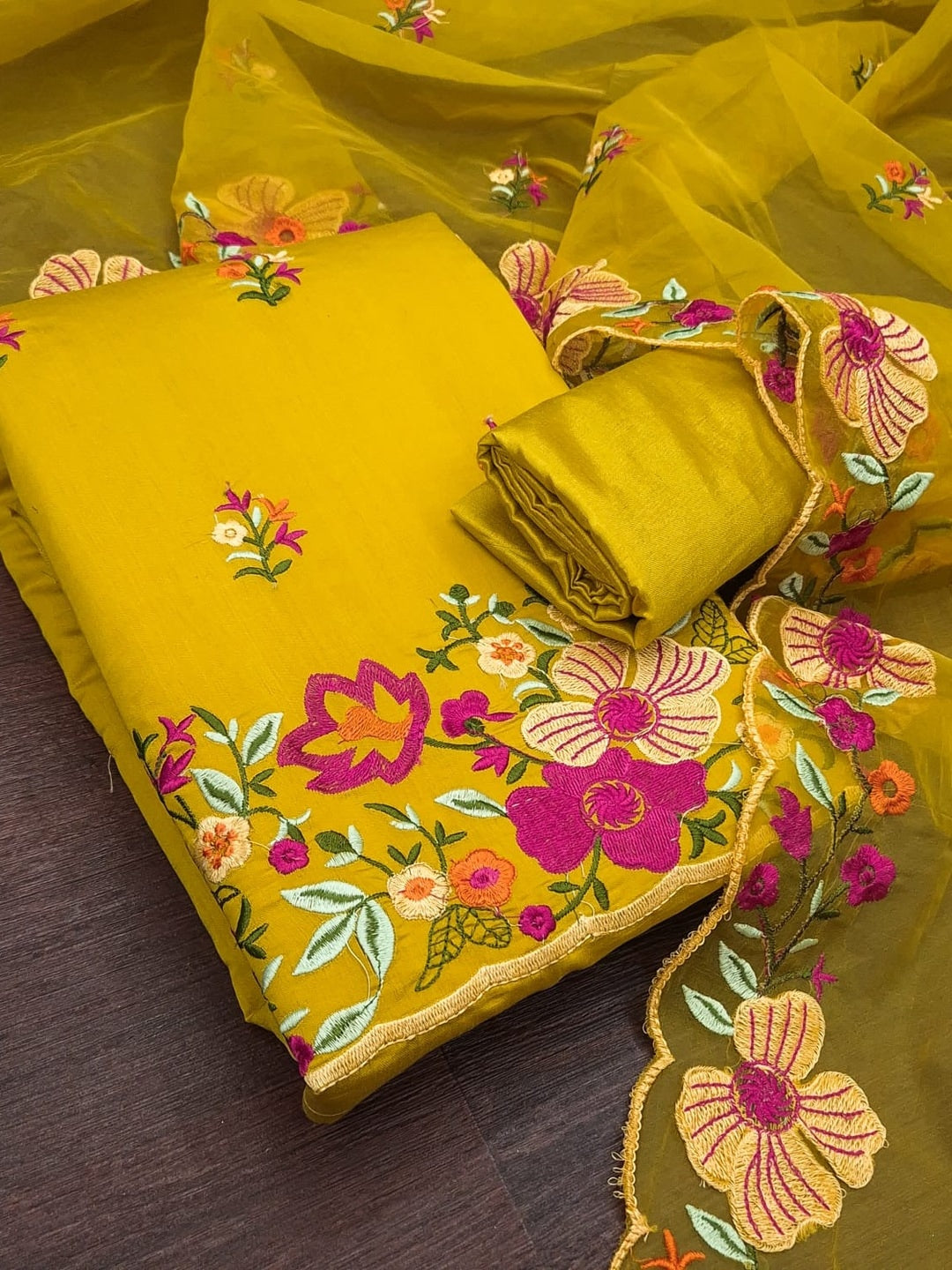 Peachmode Mustard Roman Silk Unstitched Dress Material With Multi Thread Work And Organza Dupatta - Image 1