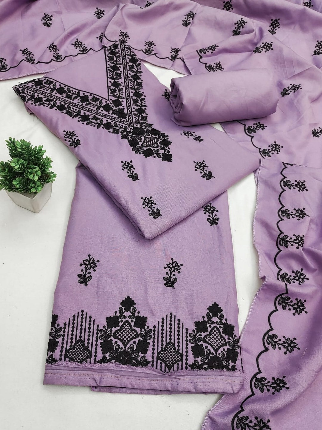 Peachmode Lavender Poly Rayon Unstitched Dress Material With Black Thread Embroidered V Neck And Daman Work And Embroidered Dupatta - Image 1