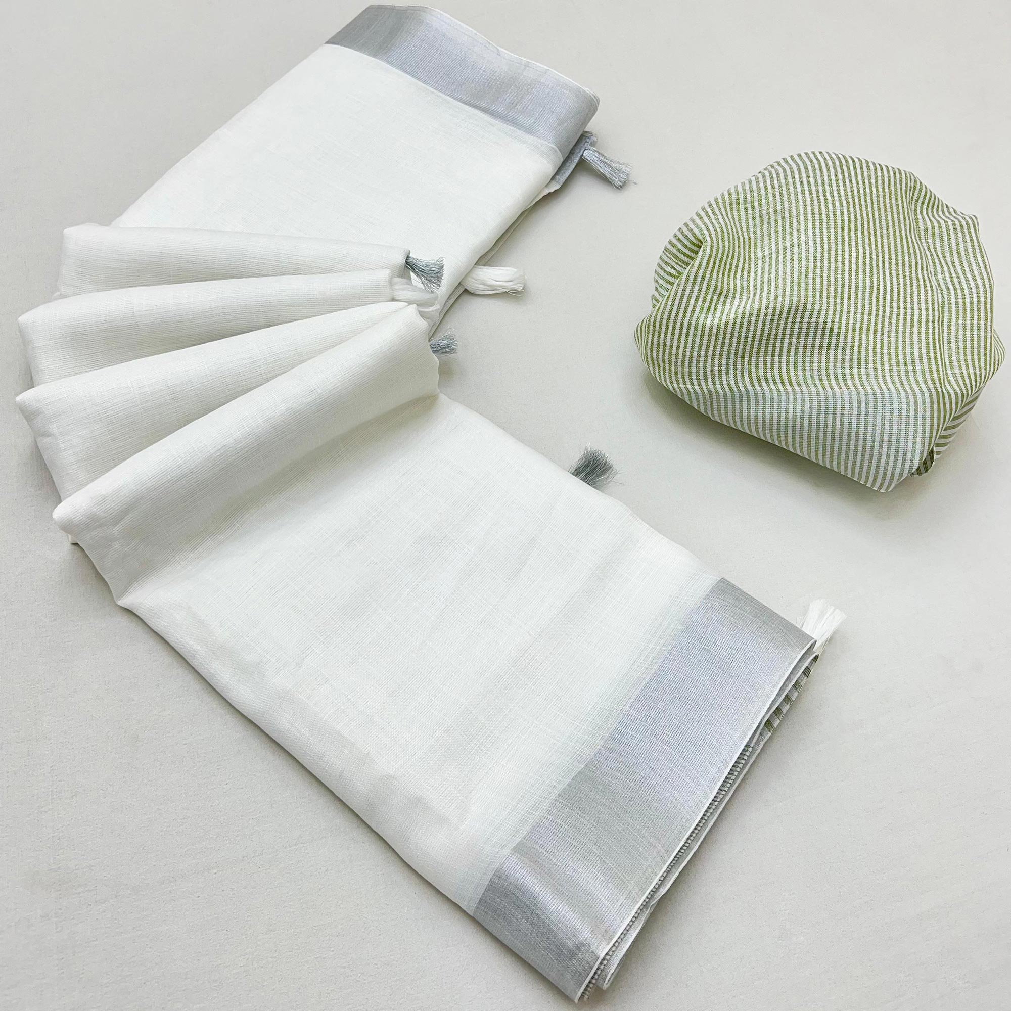 White & Light Green Zari Woven Linen Saree With Tassels