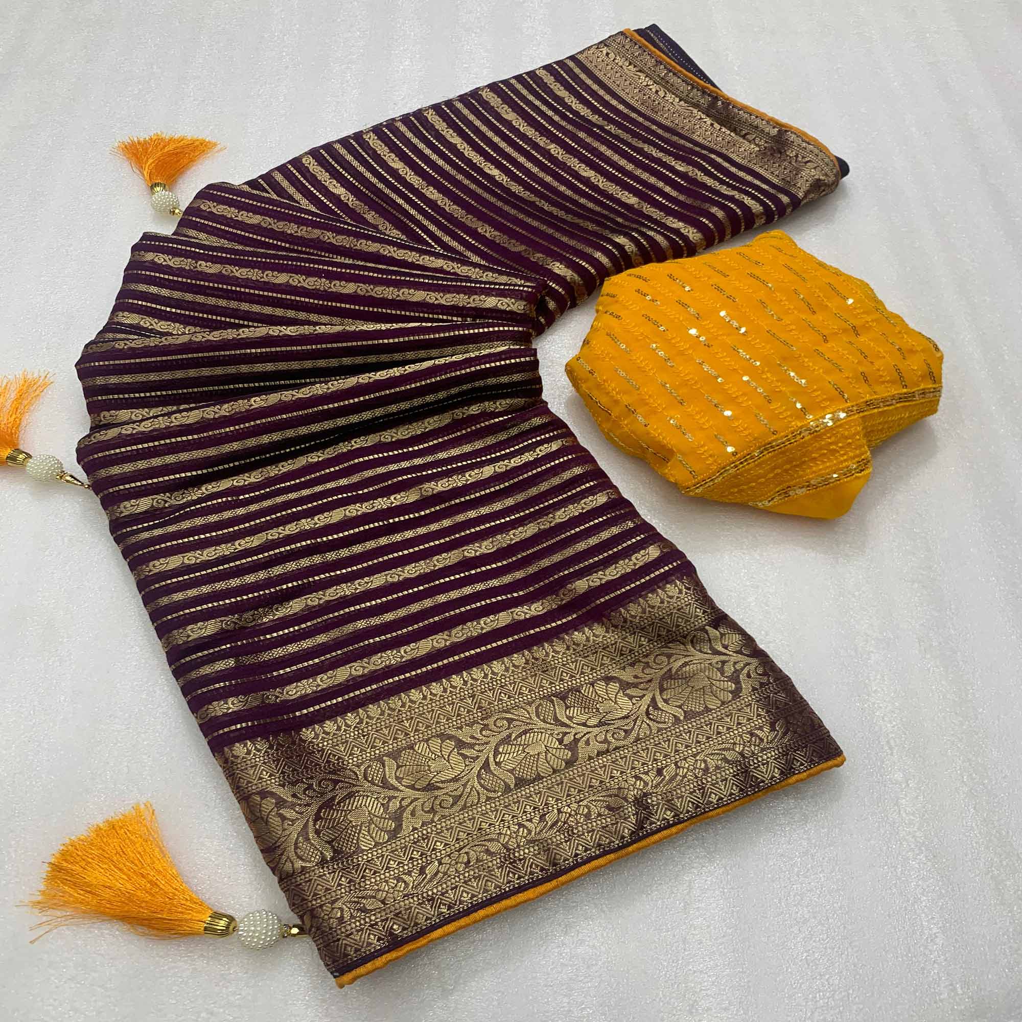 Wine Woven Georgette Saree With Tassels