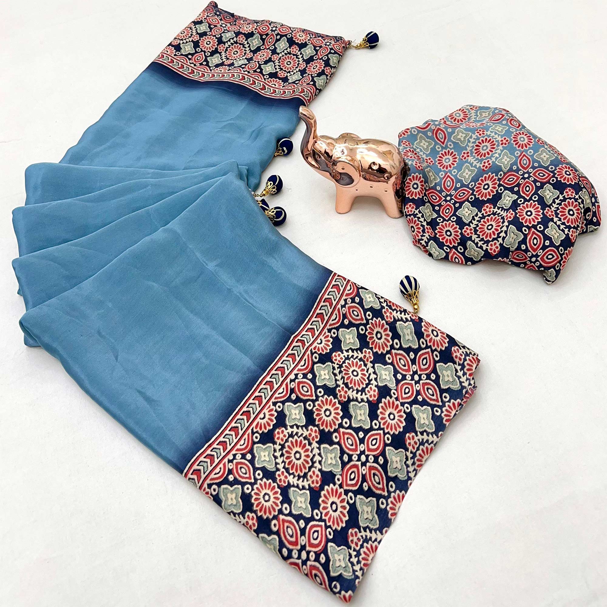 Blue Solid Satin Saree Featuring Bold Ajrakh Print and Tassel Accented Pallu
