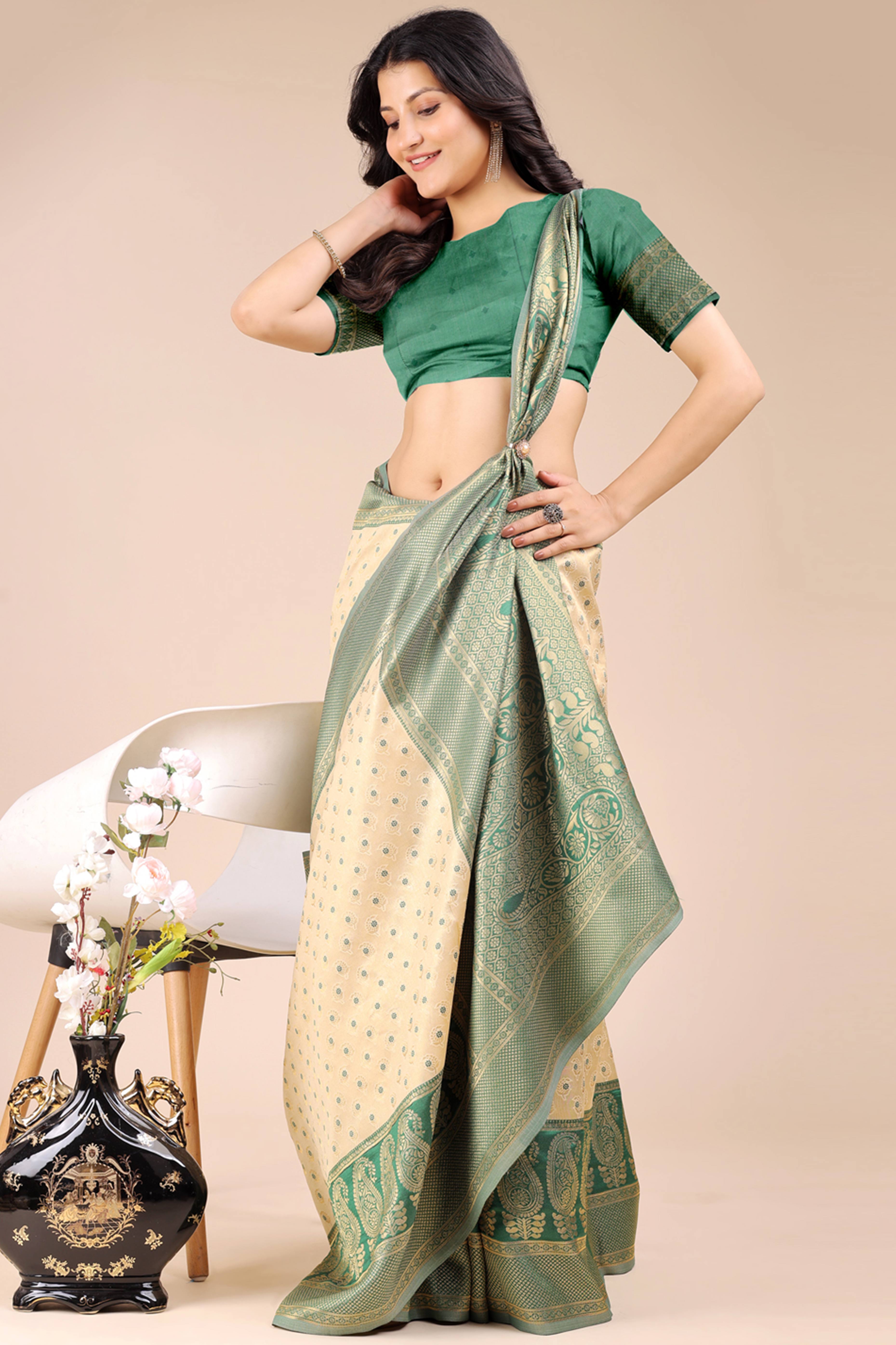 Cream Banarasi Silk Saree Featuring Lustrous Green Floral Zari Weaving and a Rich Contrast Border