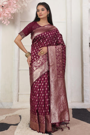 Wine Traditional Lichi Silk Blend Saree Enhanced With Floral Zari Weaving & Tassel Pallu