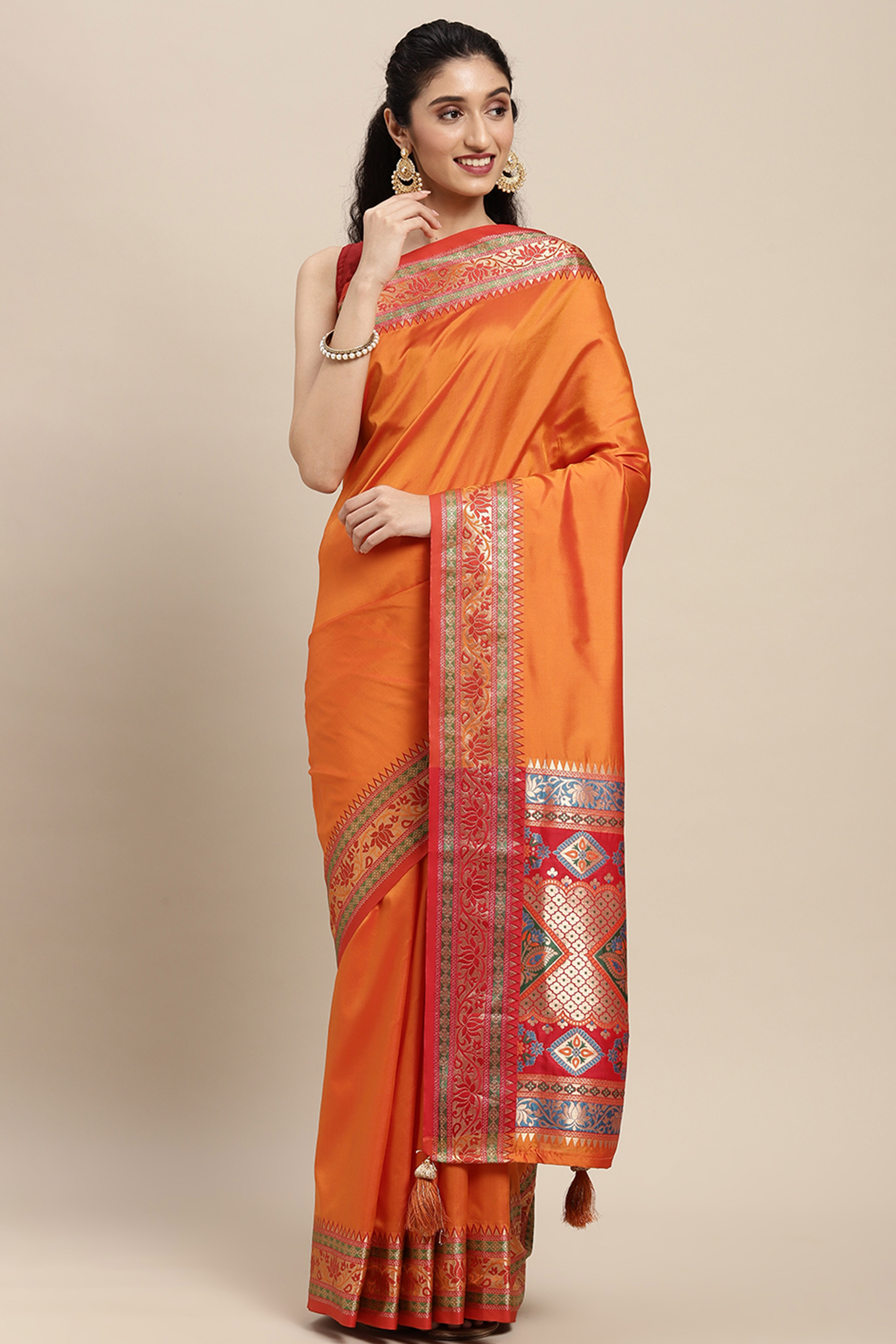 Graceful Orange Solid Saree Highlighted With Floral Zari Weaving On Silk Blend & Tassel Pallu