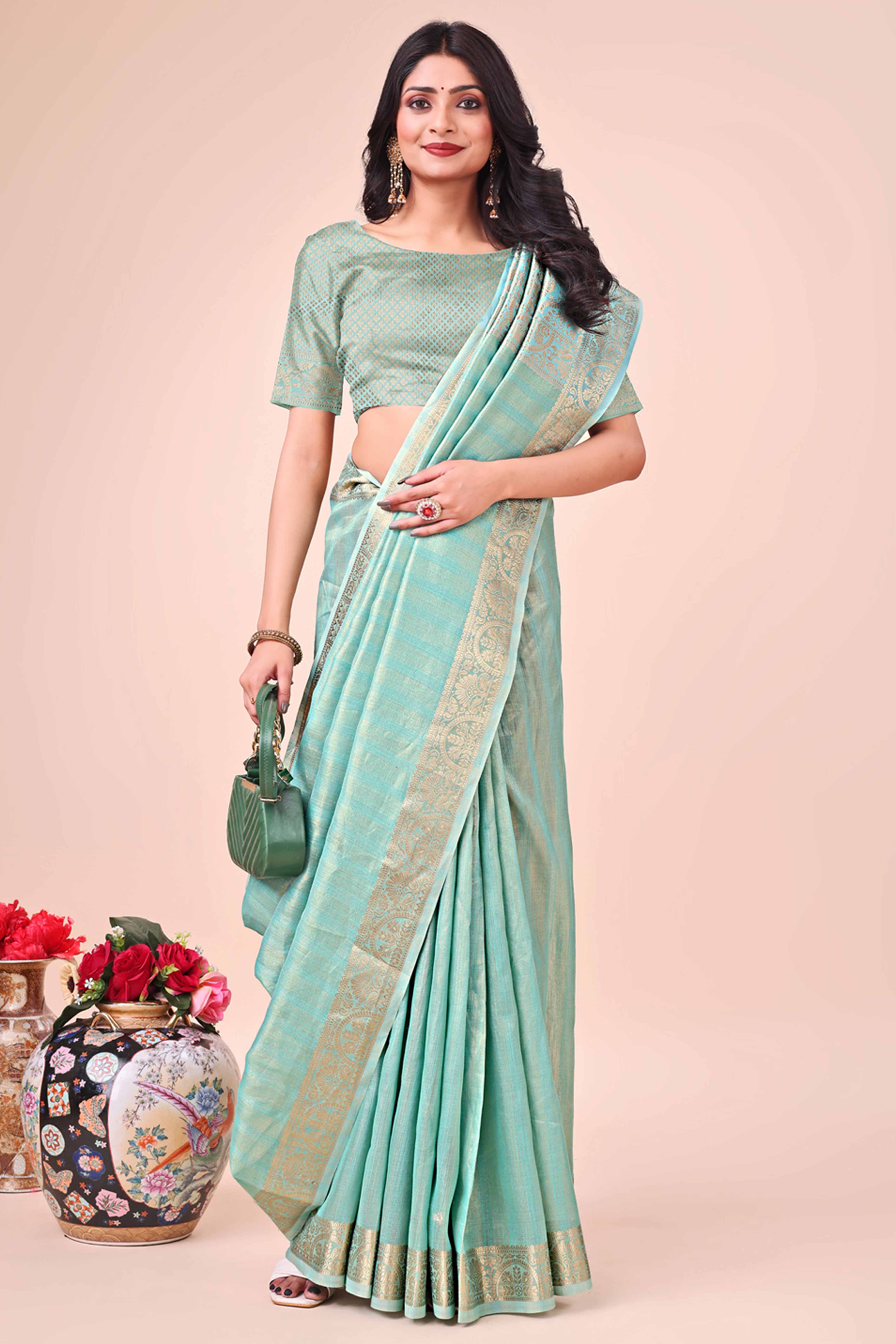 Turquoise Organza Saree With Floral Zari Weave & Tassel Accents
