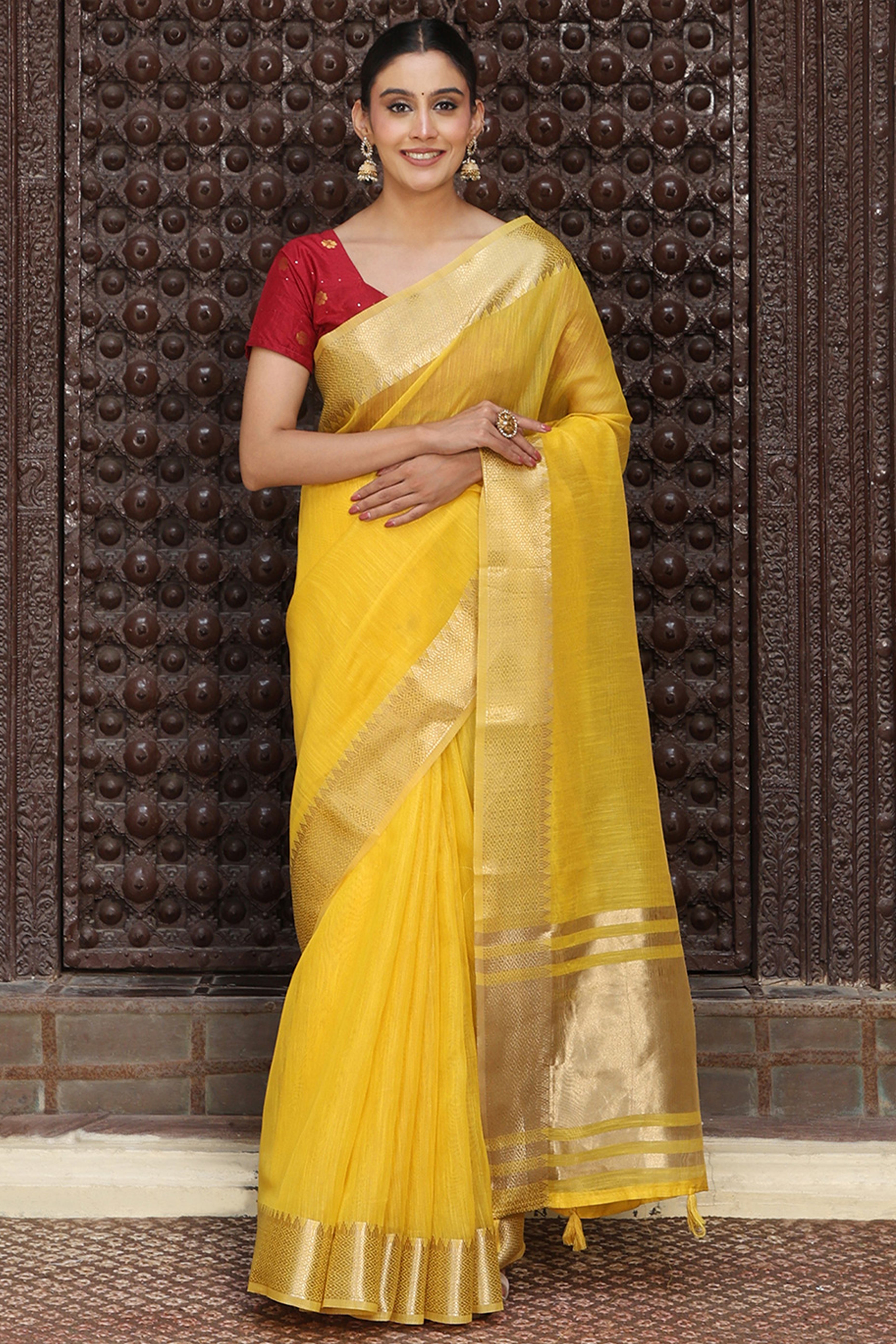Trendy Yellow Cotton Blend Saree Showcasing Elegant Zari Weaving & Tassel Border Pallu
