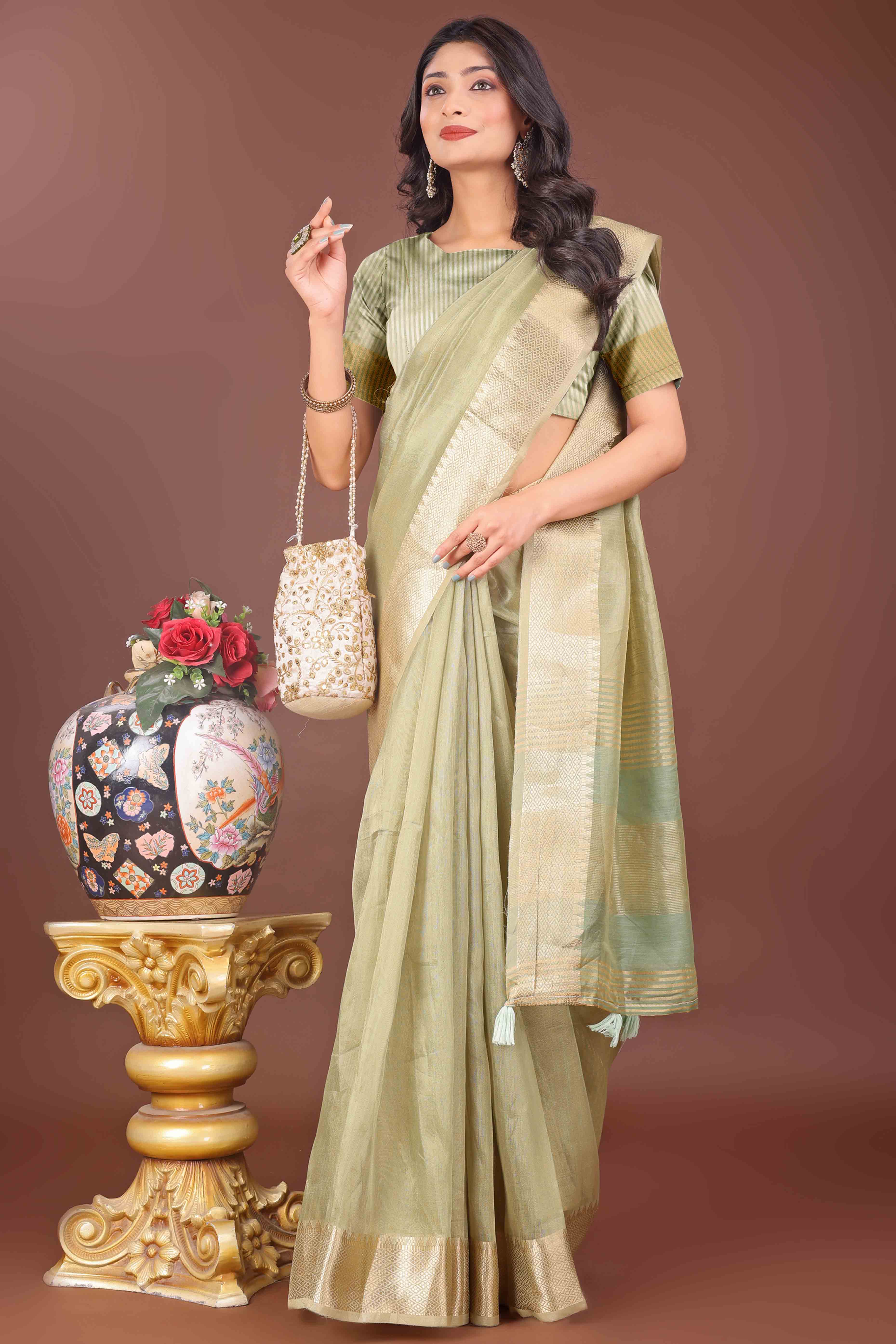 Light Green Solid With Zari Woven Organza Saree With Tassel Border