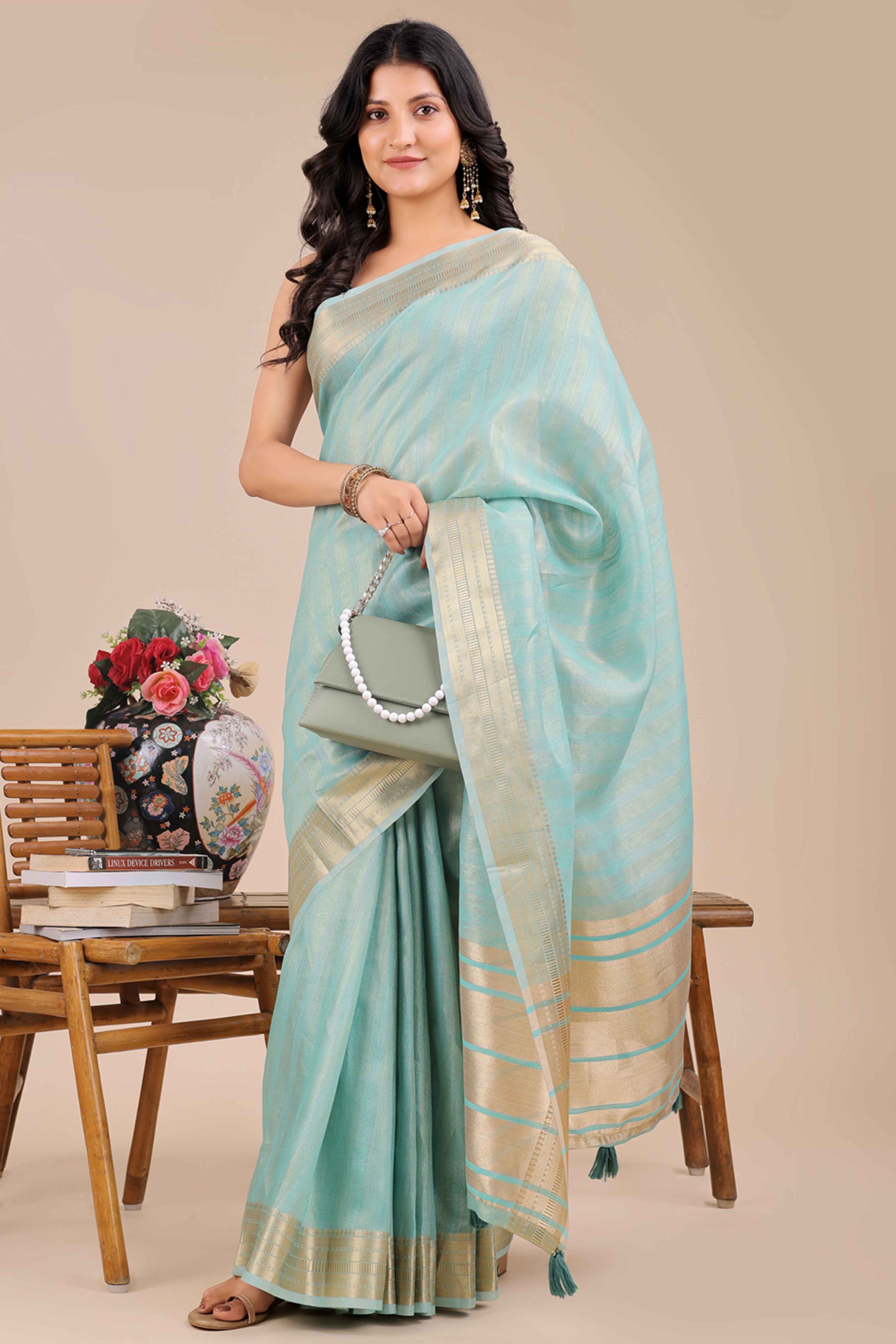 Light Turquoise Organza Saree With Intricate Weave & Elegant Tassel Accents