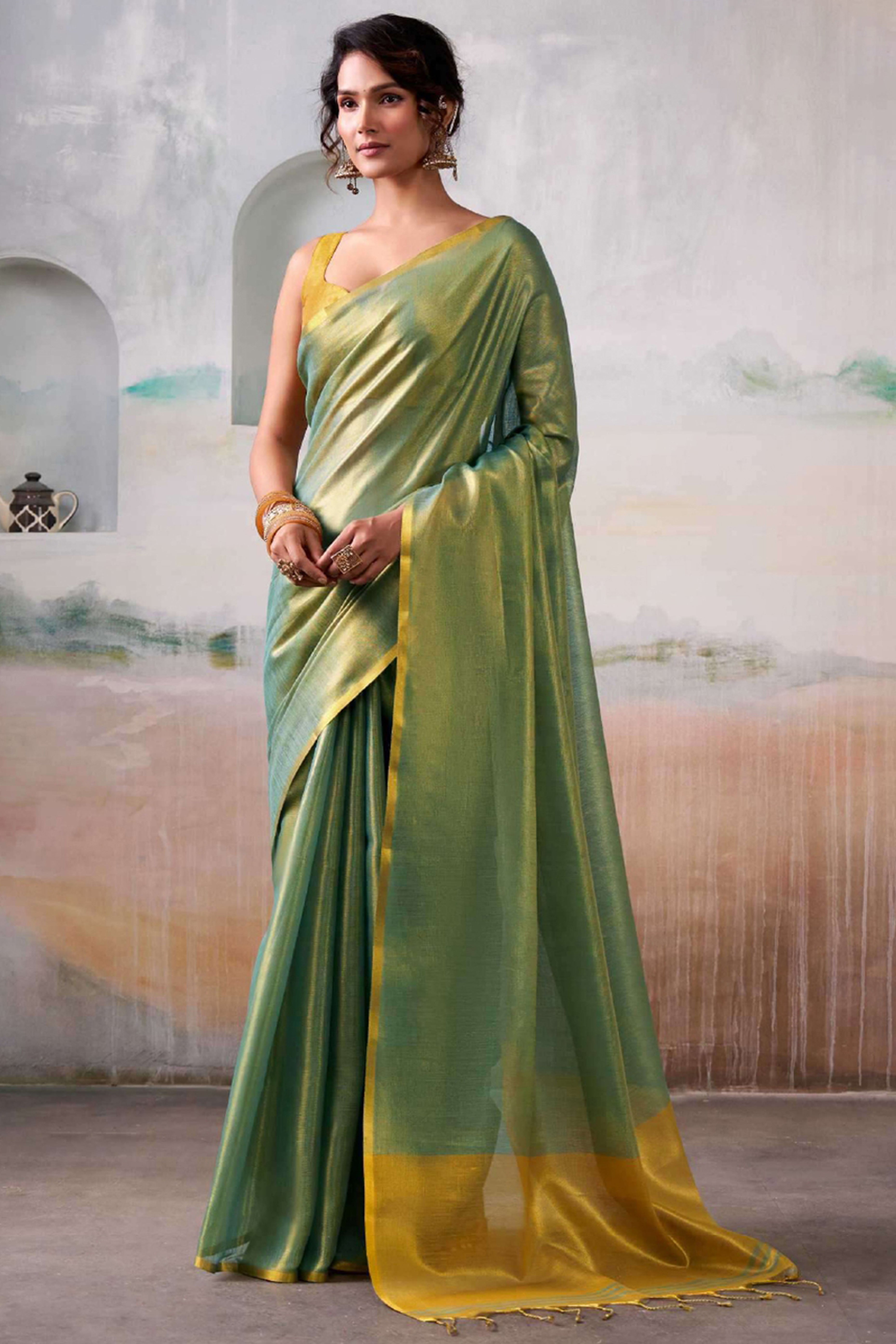 Graceful Light Green Tissue Silk Blend Saree Adorned with Intricate Zari Weaving & Tassel Pallu