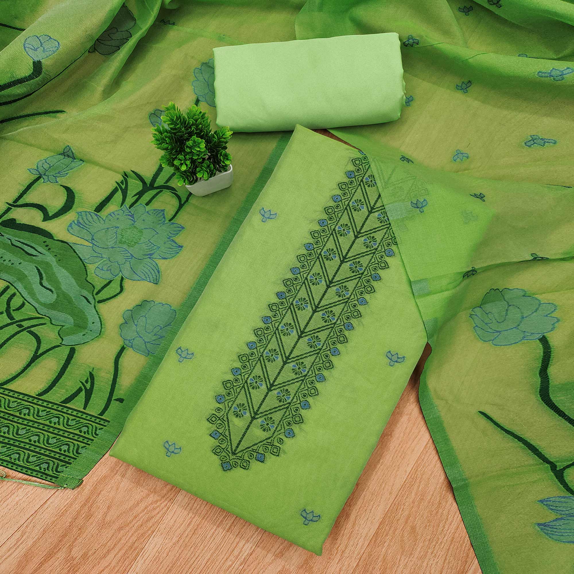 Green Ethnic Dress Material Showcasing Handloom Style Floral Zari Weaving