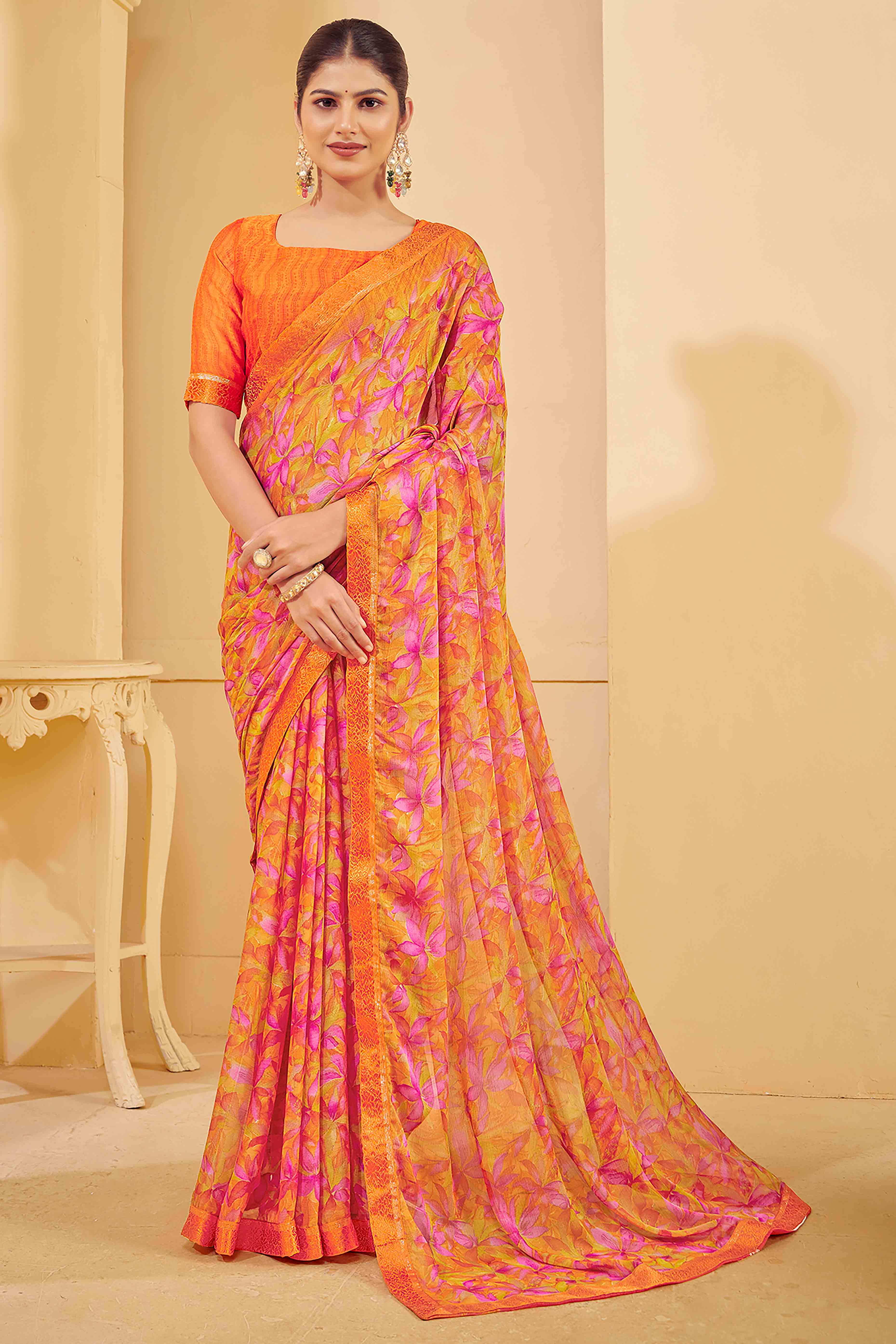 Orange Chiffon Saree Adorned With Artistic Floral Print & Finely Crafted Woven Lace Border