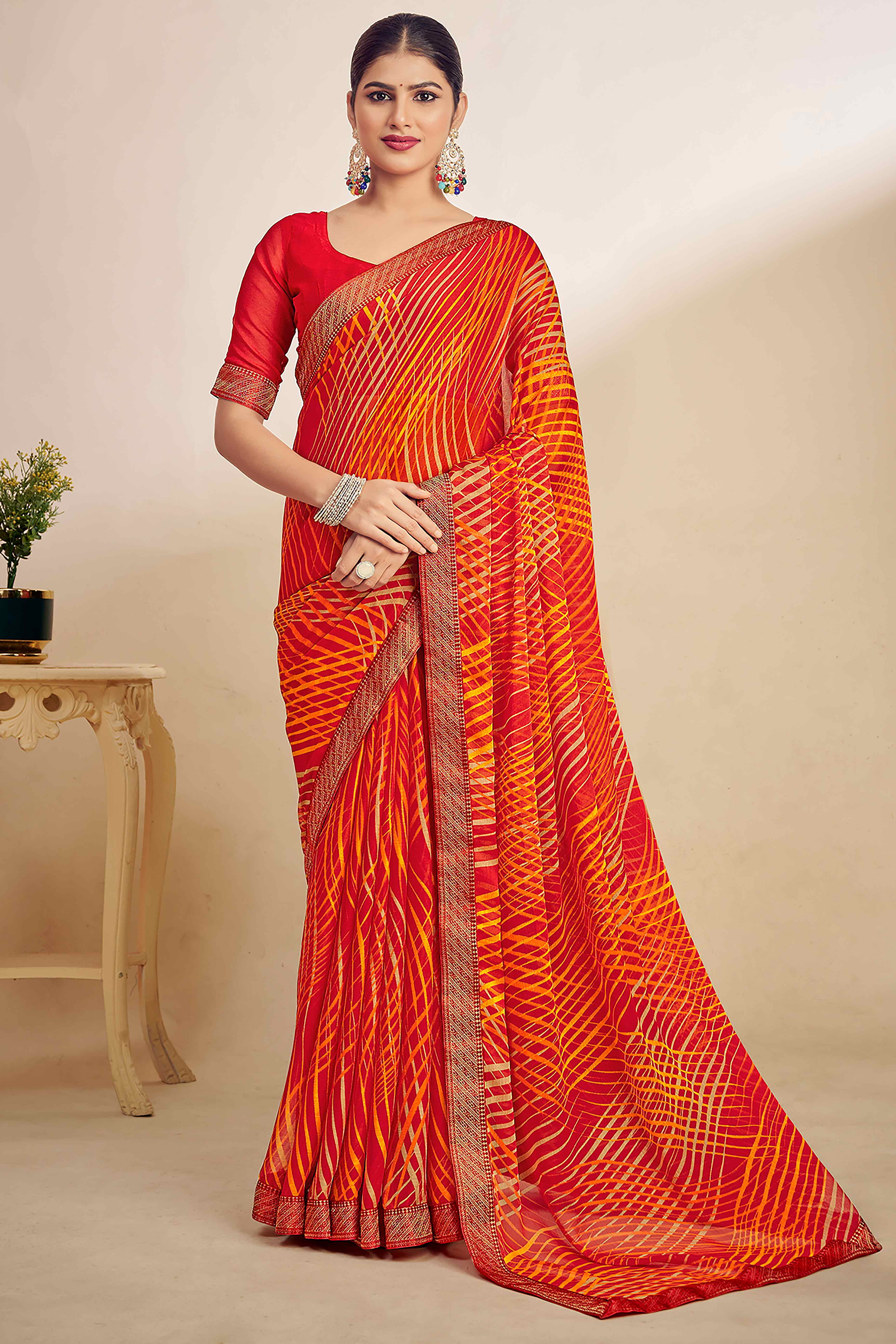 Orange Chiffon Saree Adorned With Artistic Print & Finely Crafted Woven Lace Border